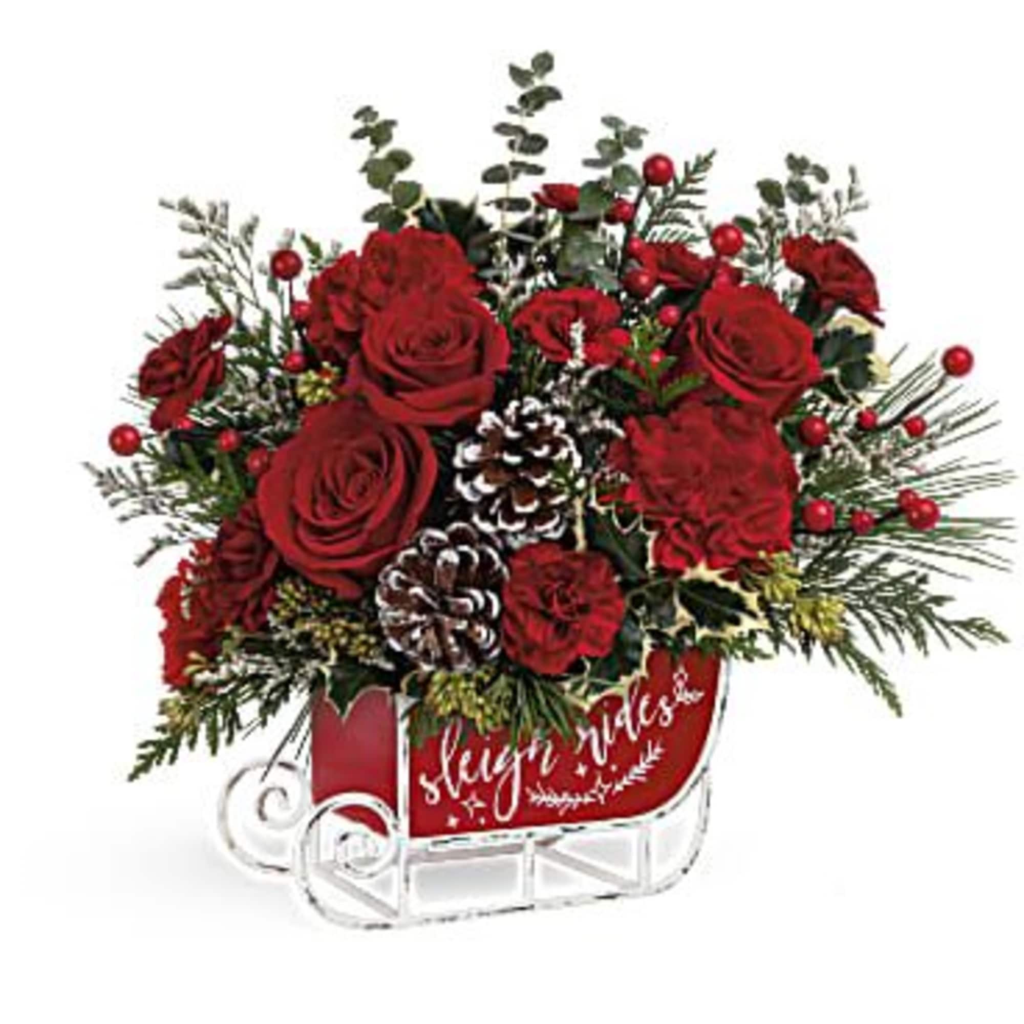 Red roses and pinecones in a sleigh-shaped container