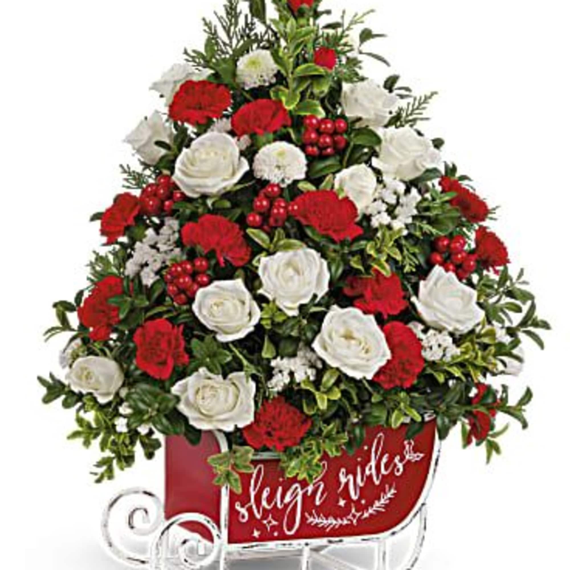 Red and white floral arrangement in a sleigh-shaped container