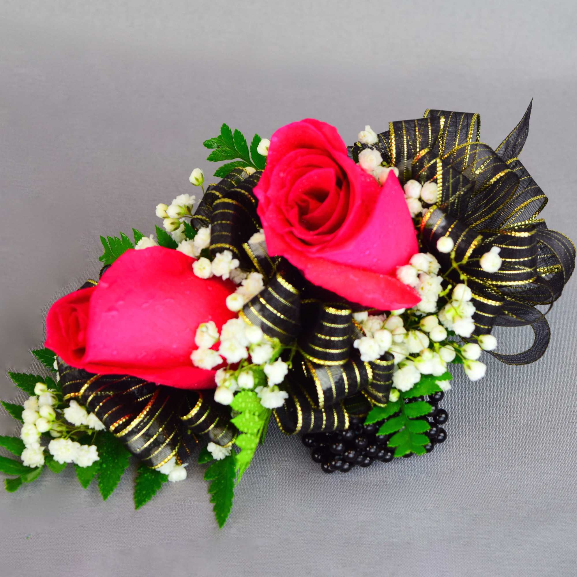 Two hot pink roses with white filler and black ribbon trim