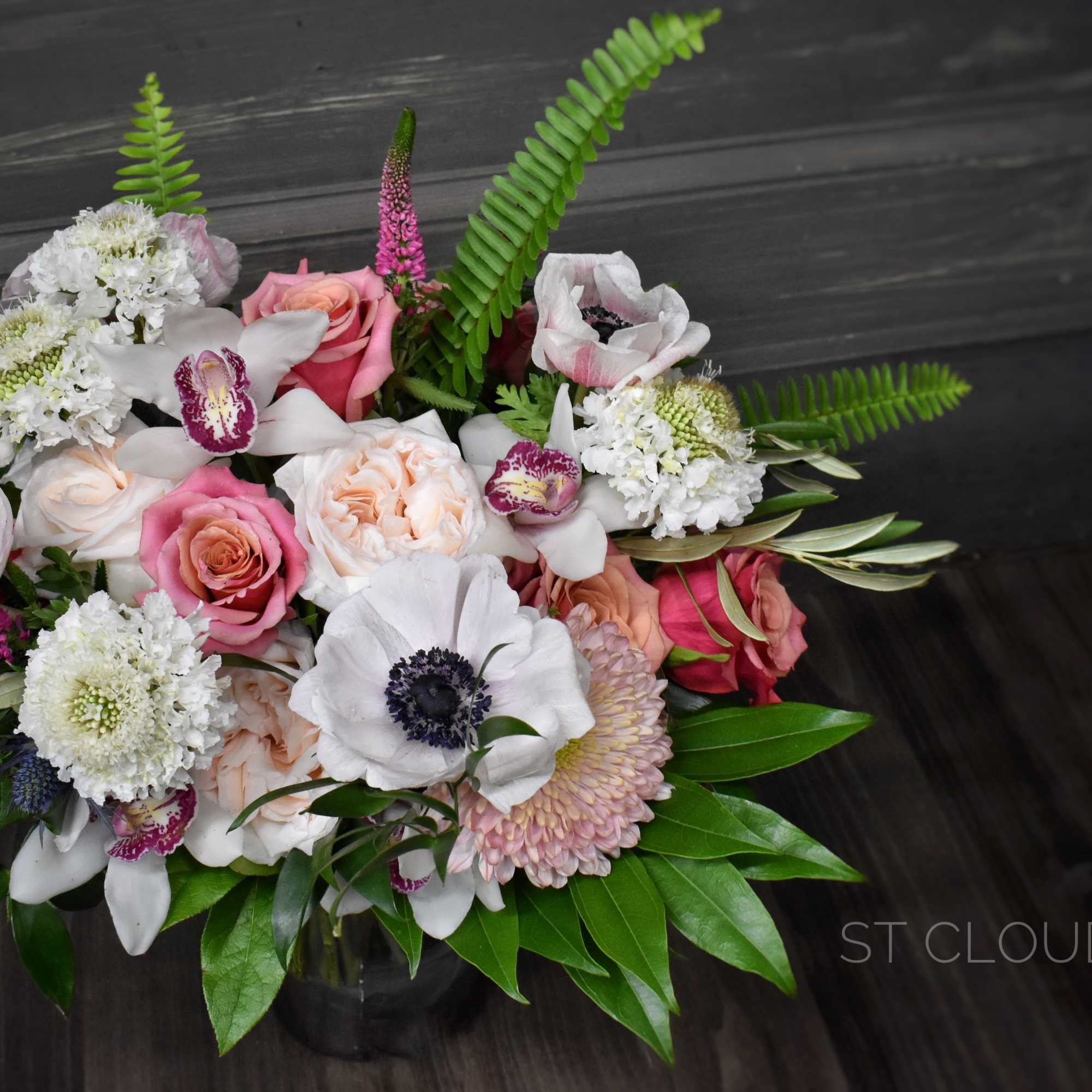 Mixed bouquet of pink and white flowers with green foliage