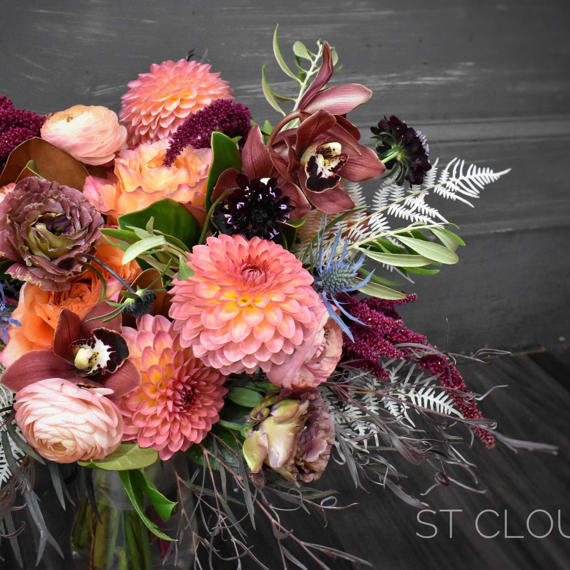 Bouquet of pink and peach flowers with burgundy accents