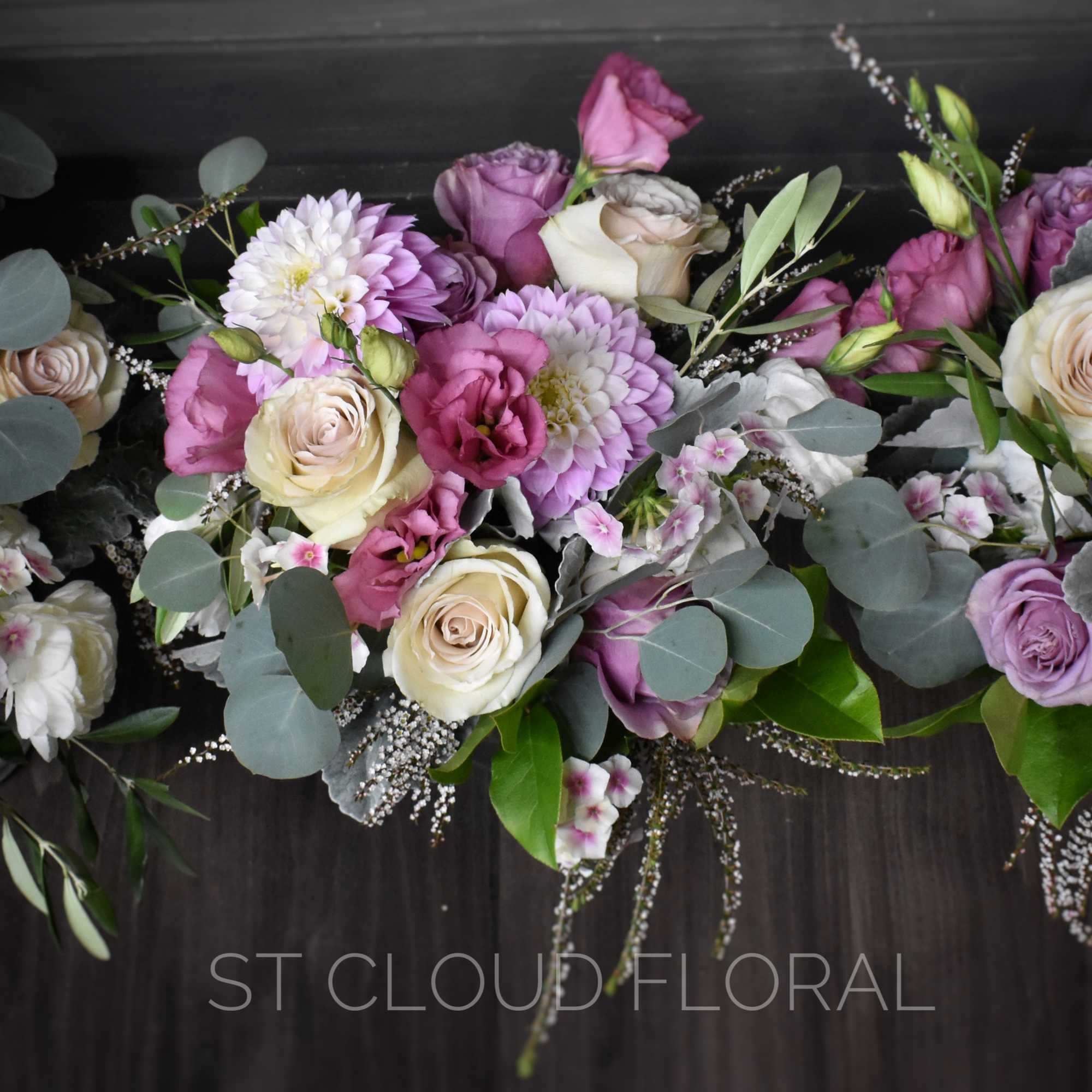 Three pastel floral arrangements with roses and purple blooms