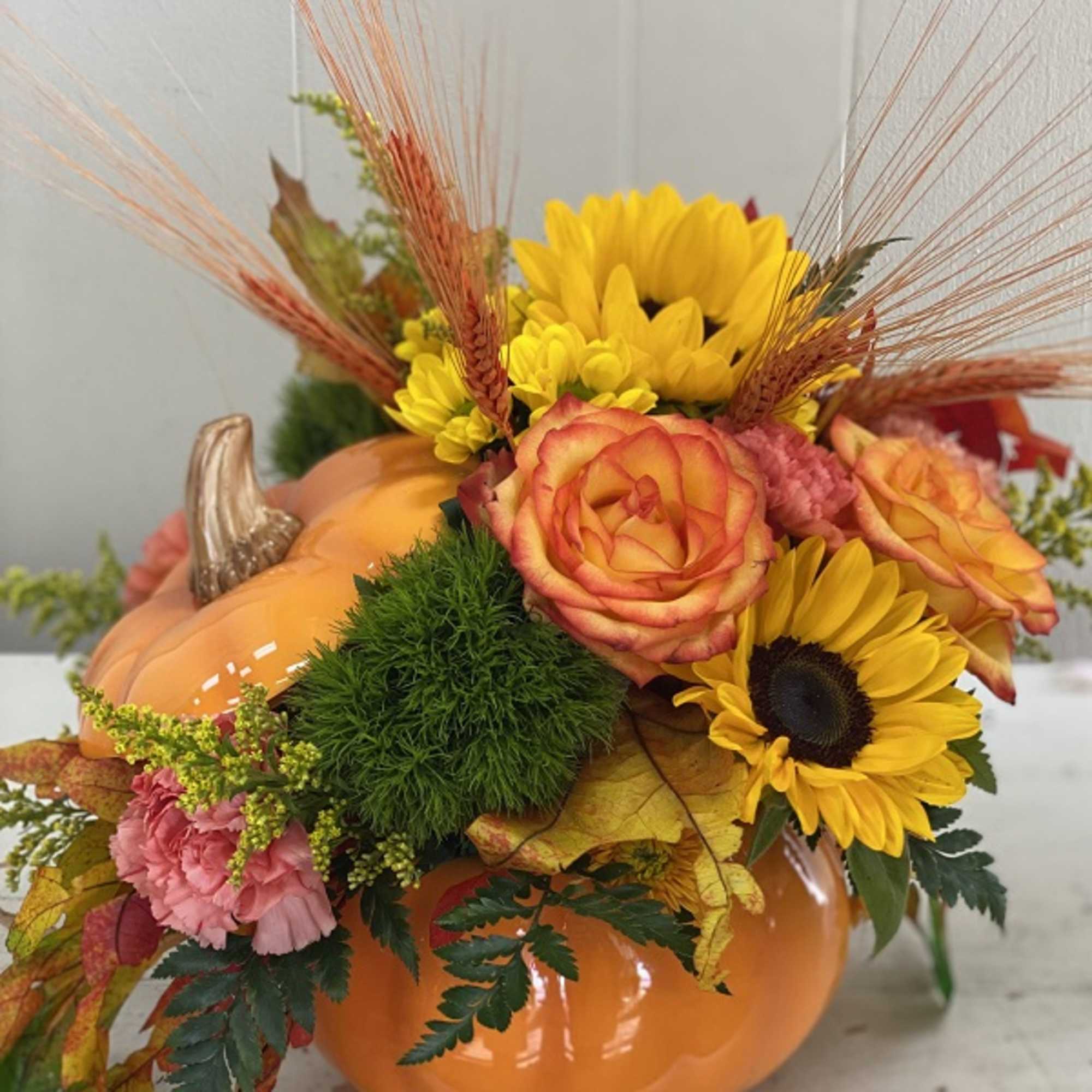 Bright fall flowers, leaves and more fill a hand-painted ceramic pumpkin that, photo 2 of 3