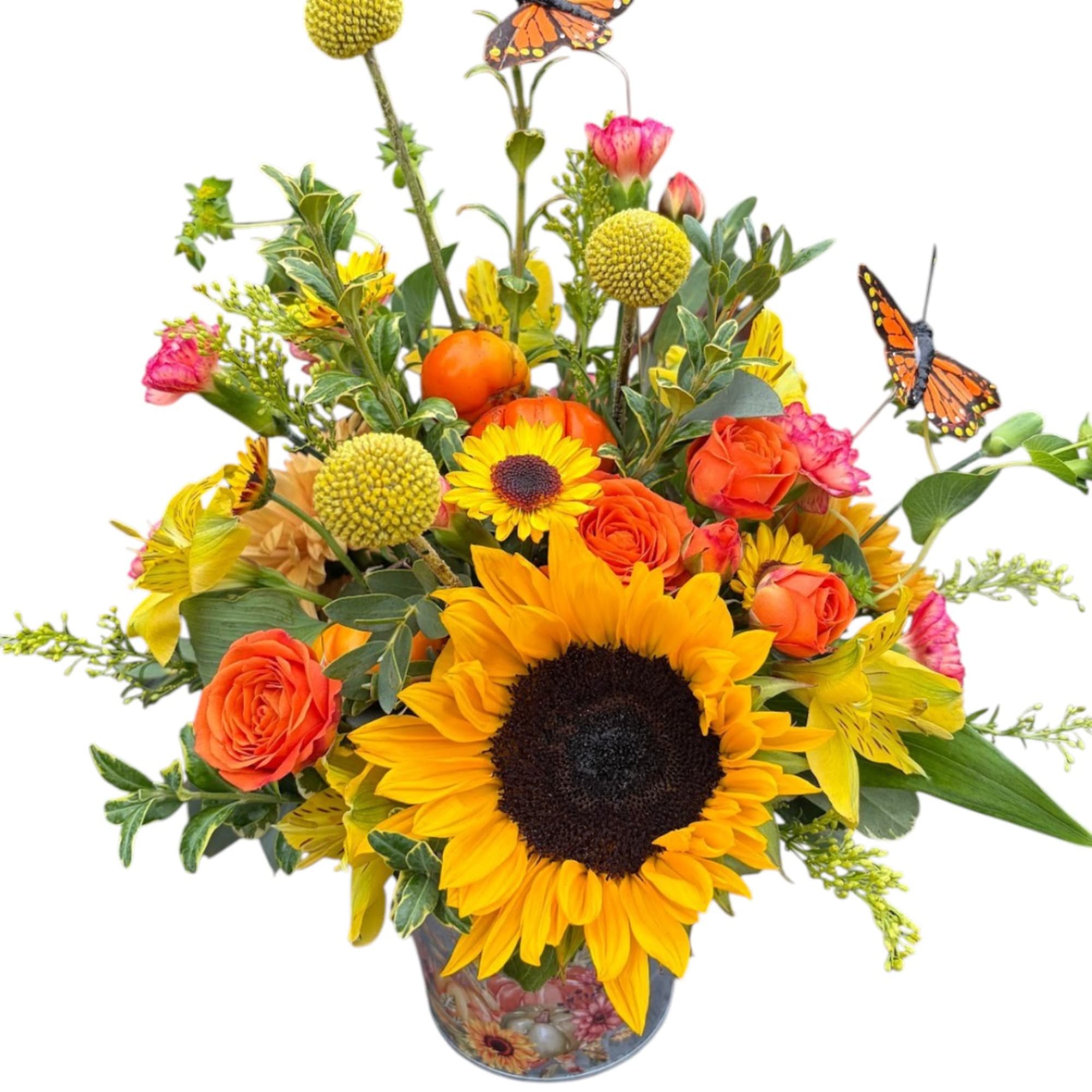 Sunflower and orange rose arrangement in a decorative vase with butterfly picks
