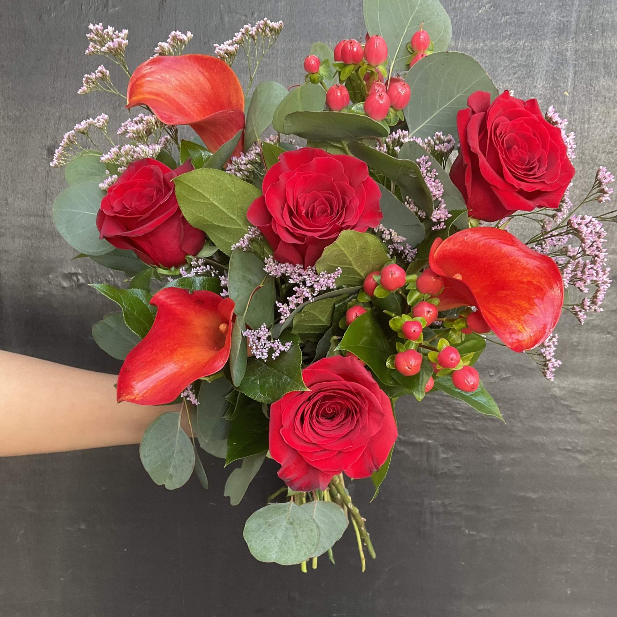 Bouquet of red roses and orange calla lilies with greenery, photo 2 of 3