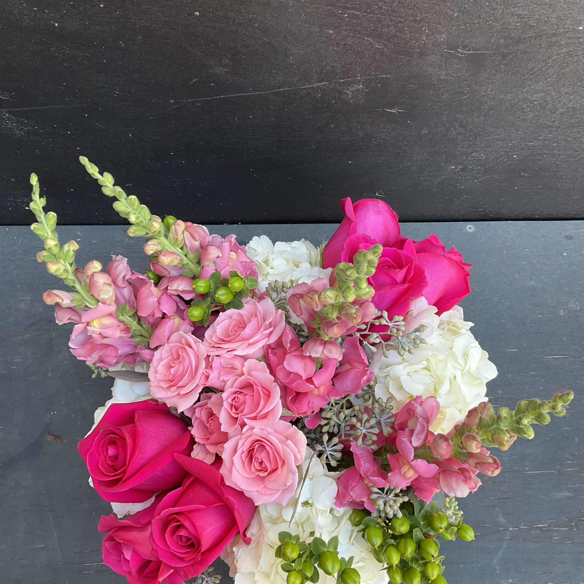 Pink and white floral bouquet with hot pink roses and hydrangeas