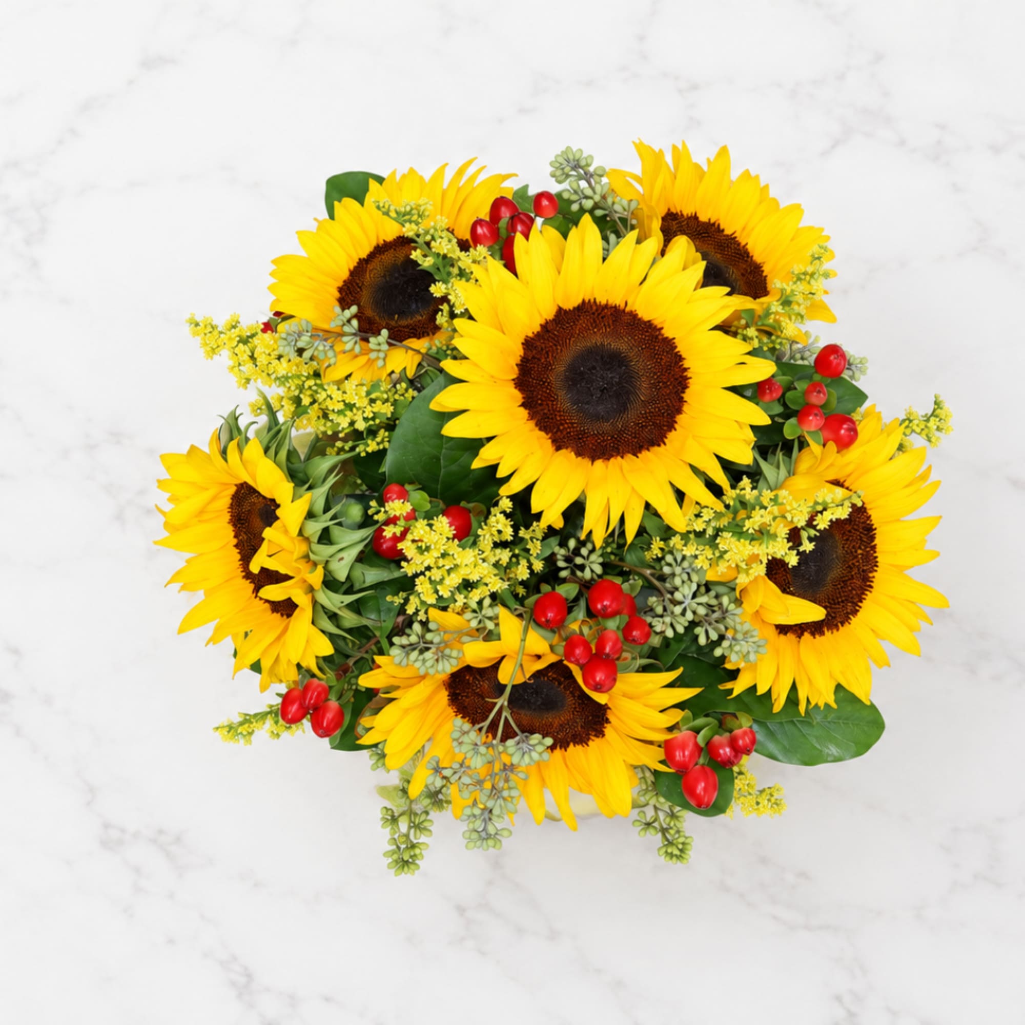 Bouquet of yellow sunflowers with red berry accents