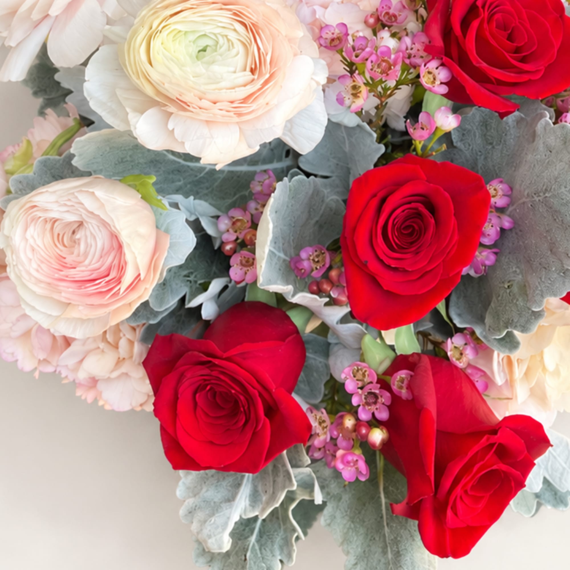 Bouquet of red and blush roses with pale filler flowers