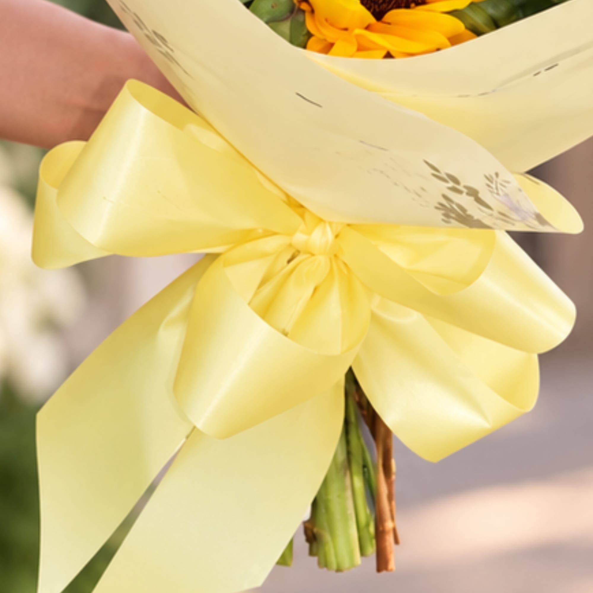 Yellow bouquet wrapped with a large satin bow