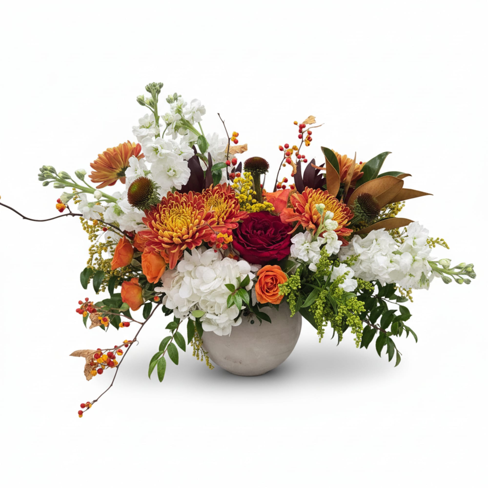 Mixed floral arrangement in a round vase with white, orange, and red blooms
