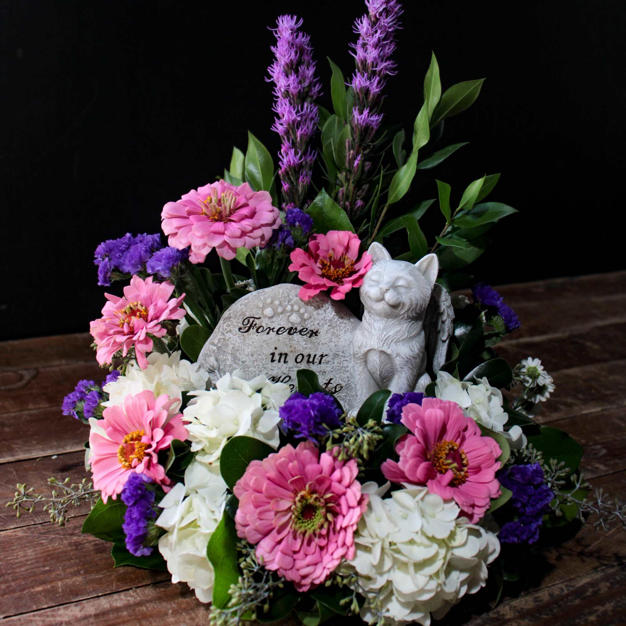 An arrangement in remembrance of your precious fur baby with a keepsake