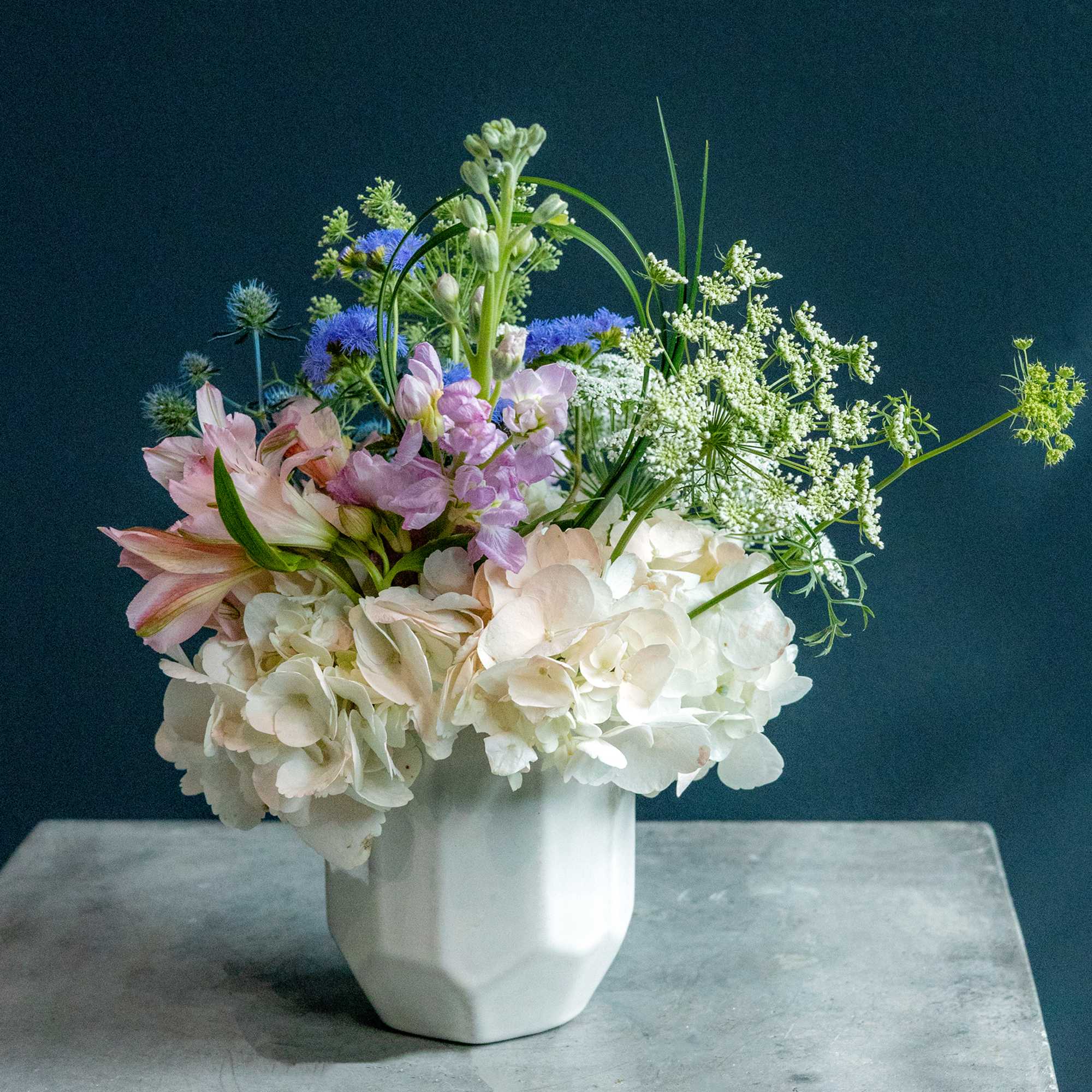 Mixed pastel bouquet in a white ceramic vase
