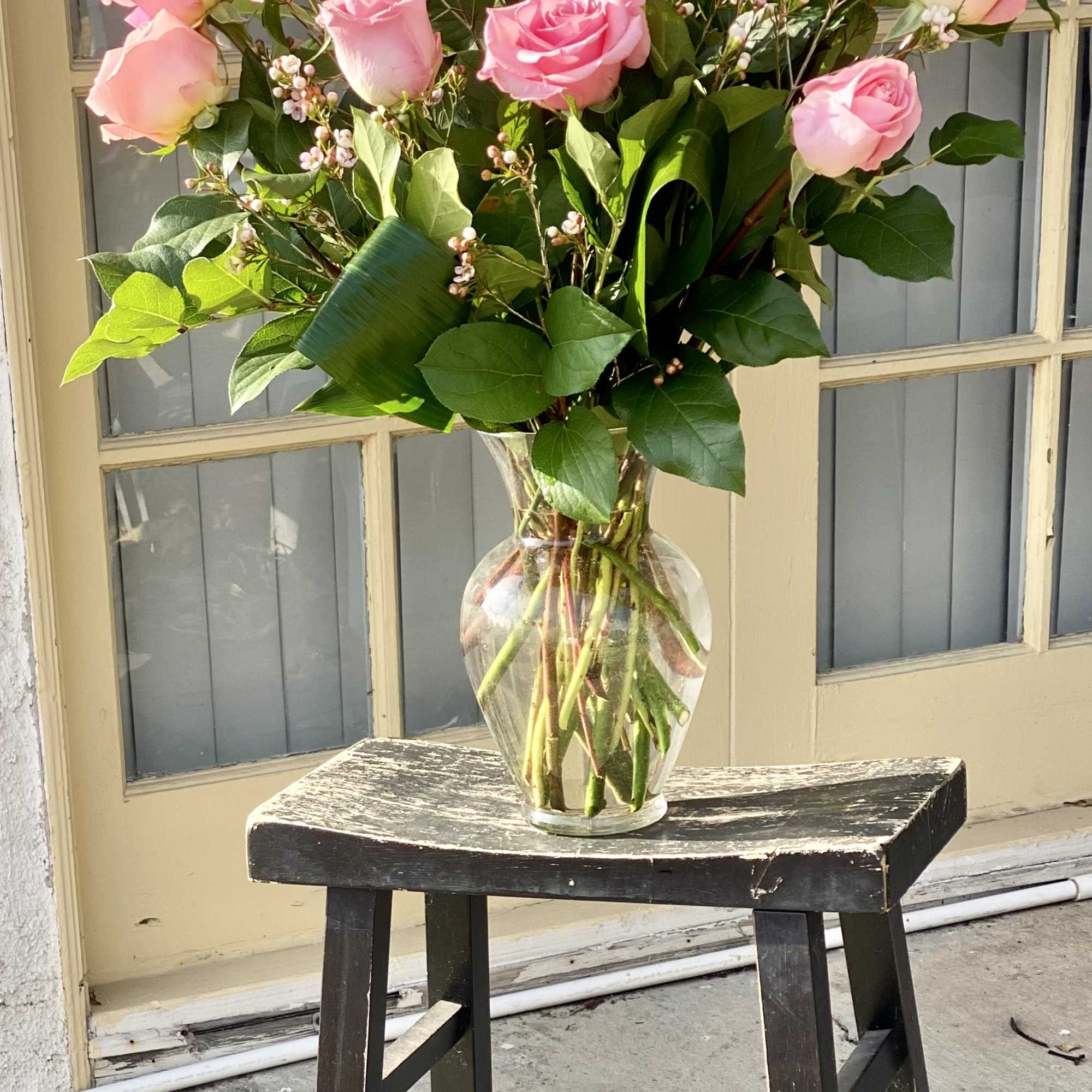 Pink roses arranged in a clear glass vase, photo 2 of 2
