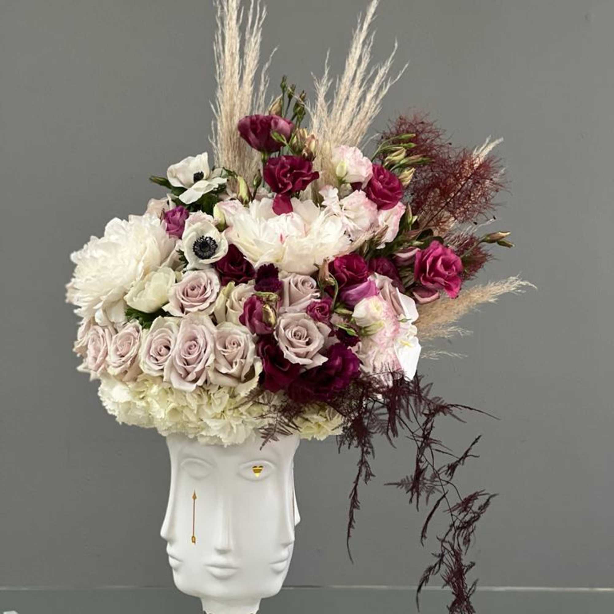 Bouquet of pink and white roses in a white sculptural vase