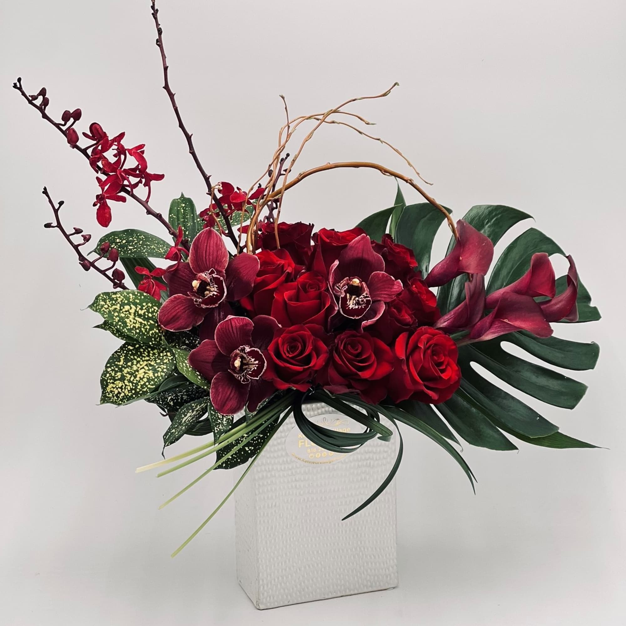 Red roses and burgundy orchids in a white vase, photo 3 of 3