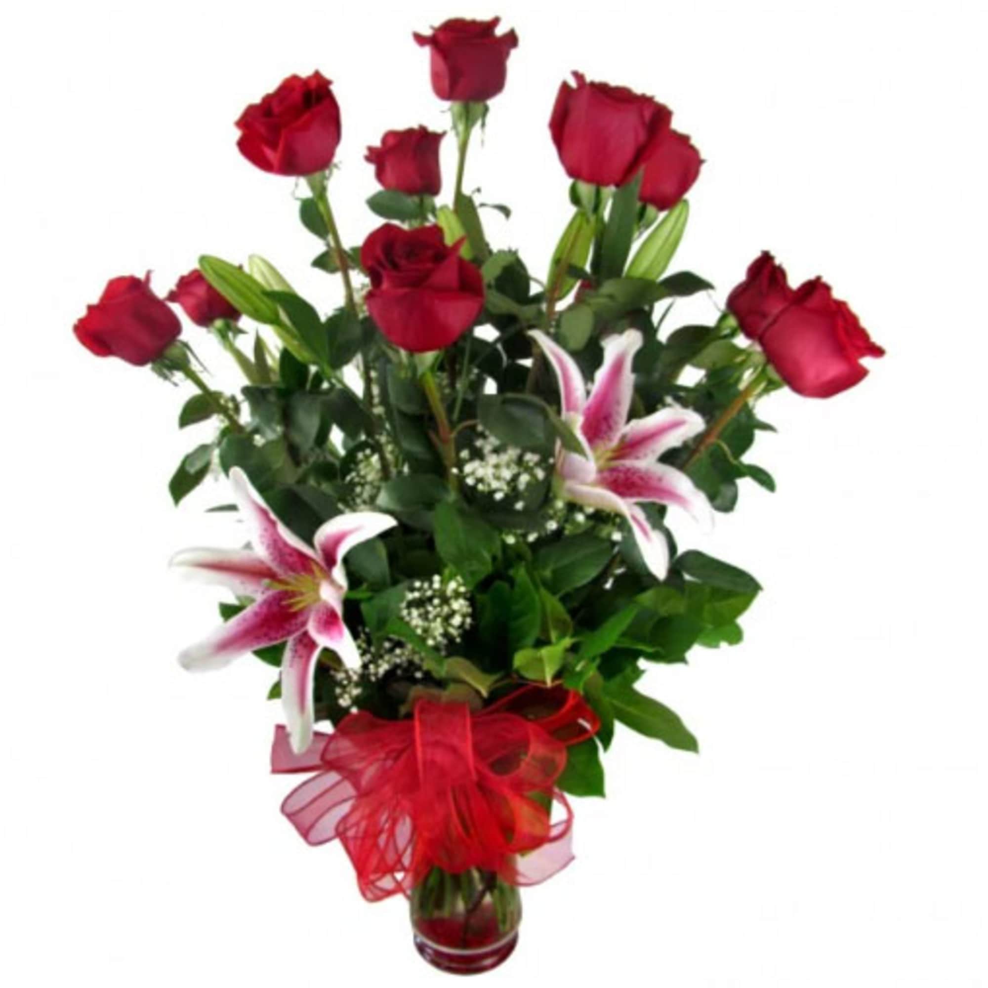 Red roses and pink lilies in a glass vase with a red ribbon