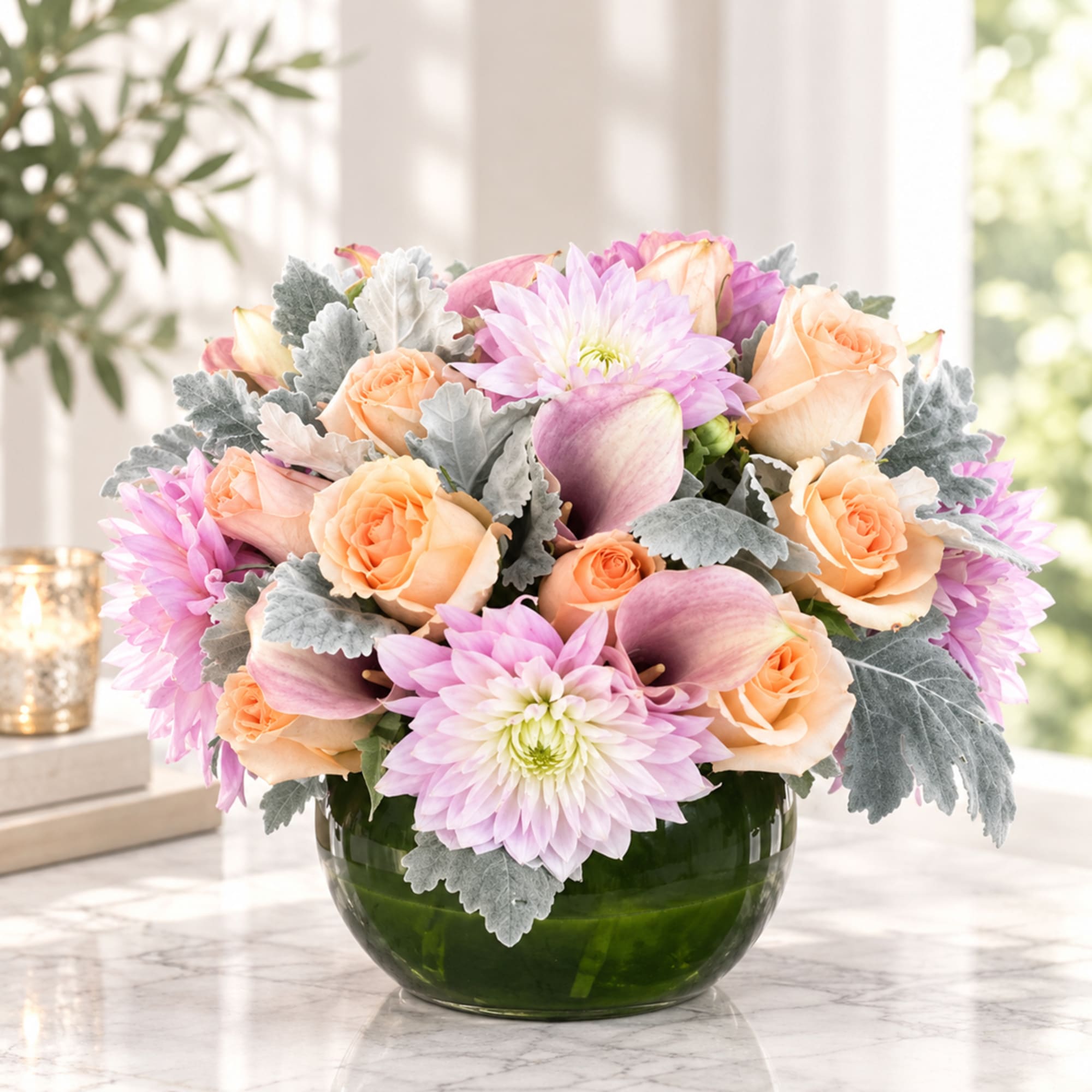 Peach roses and pink dahlias in a green glass bowl