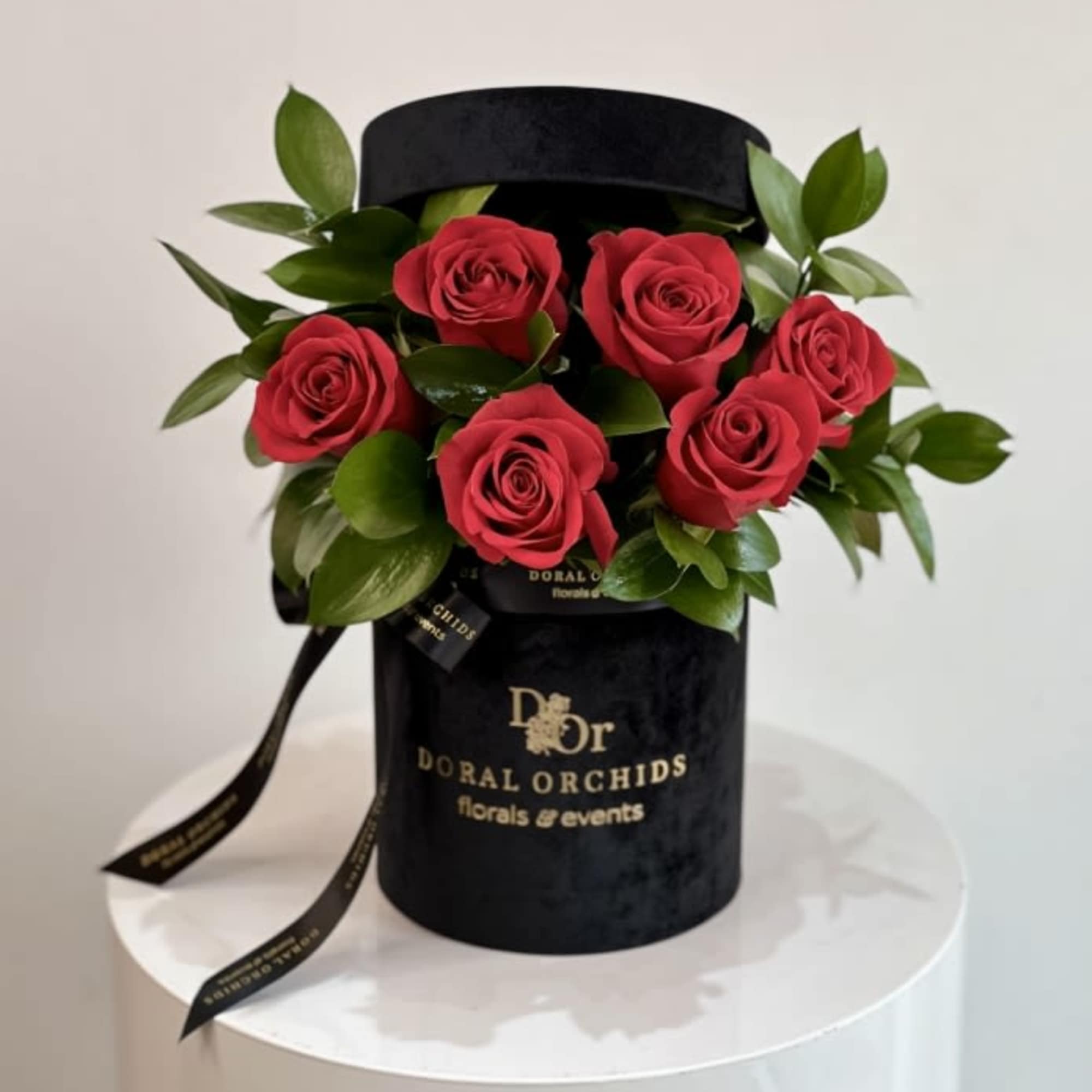 Elegant and timeless, this arrangement showcases velvety red roses surrounded by lush