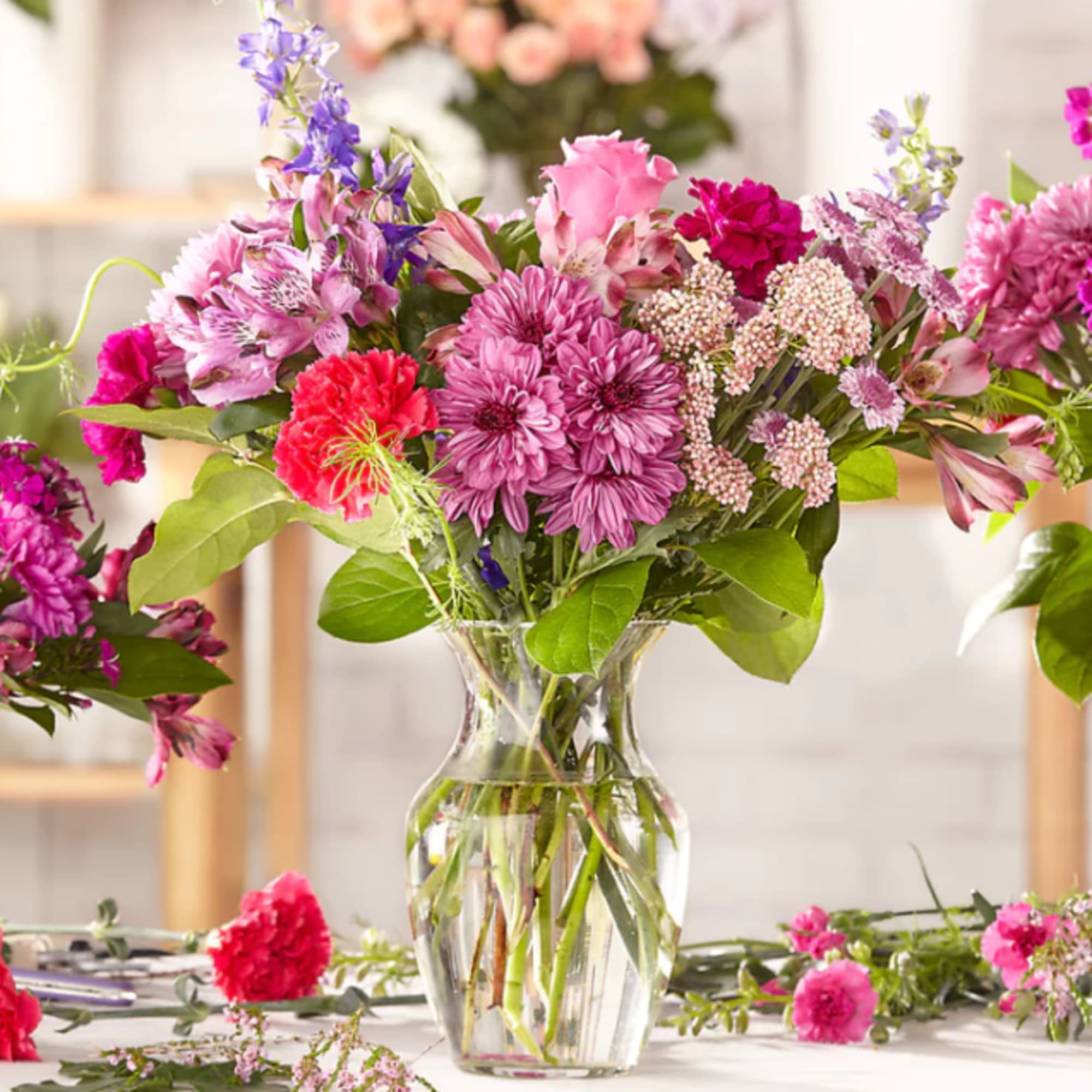Mixed pink and purple bouquet in a clear glass vase