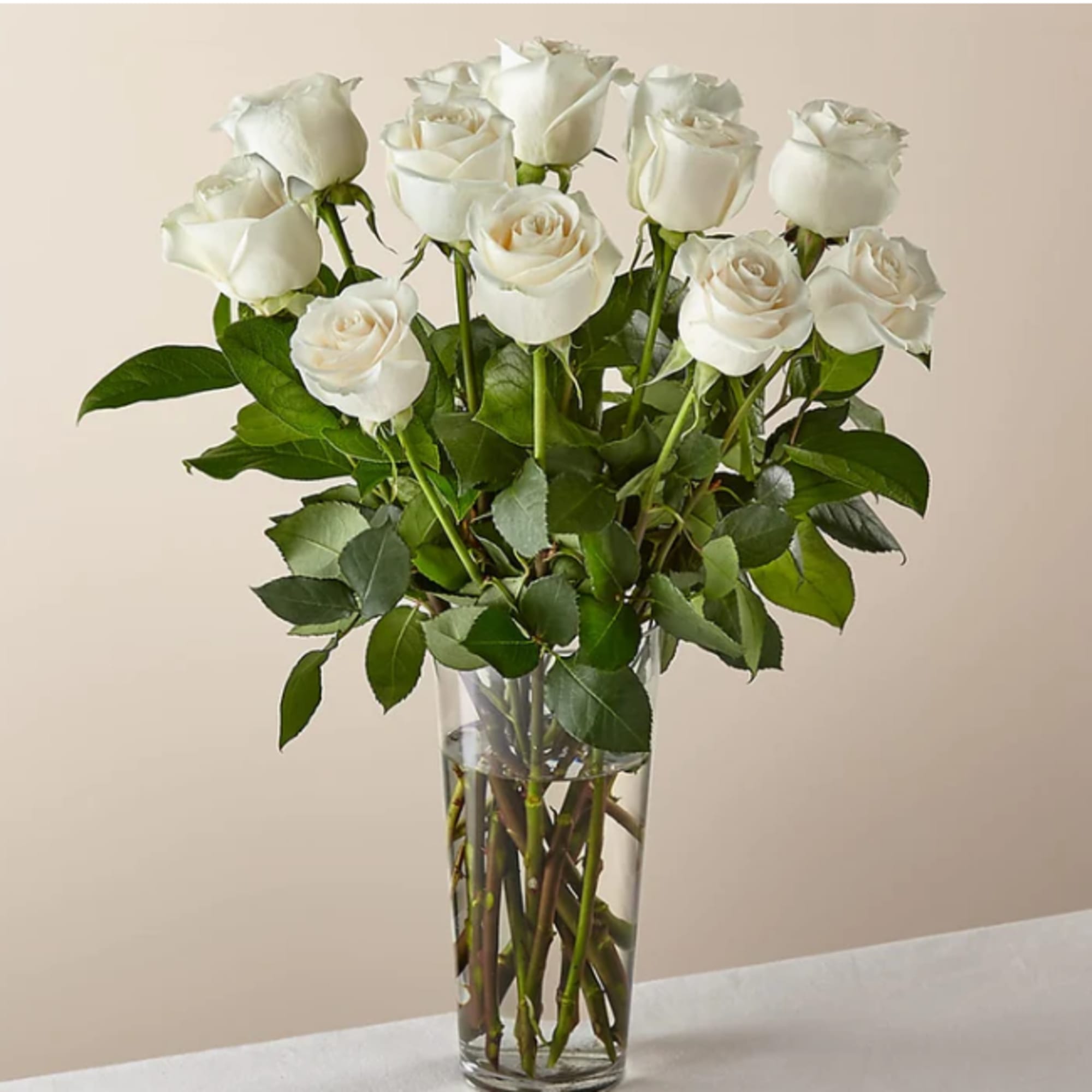 White roses arranged in a clear glass vase