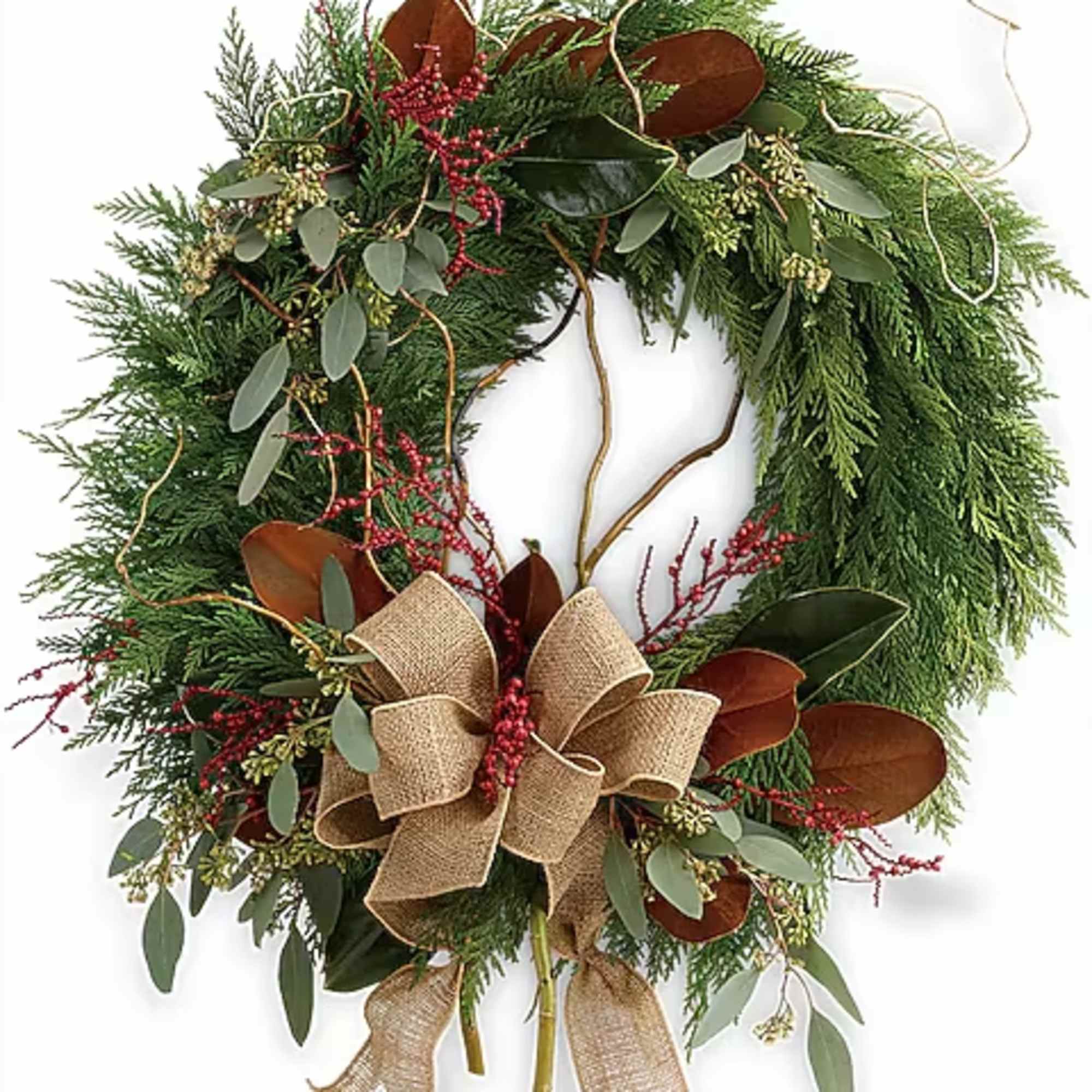 Holiday wreath with evergreen foliage, red berries, and a burlap bow