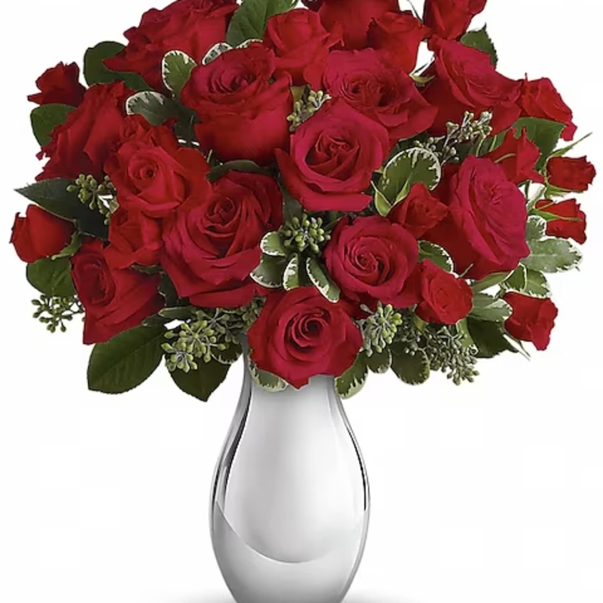 Red roses arranged in a clear glass vase