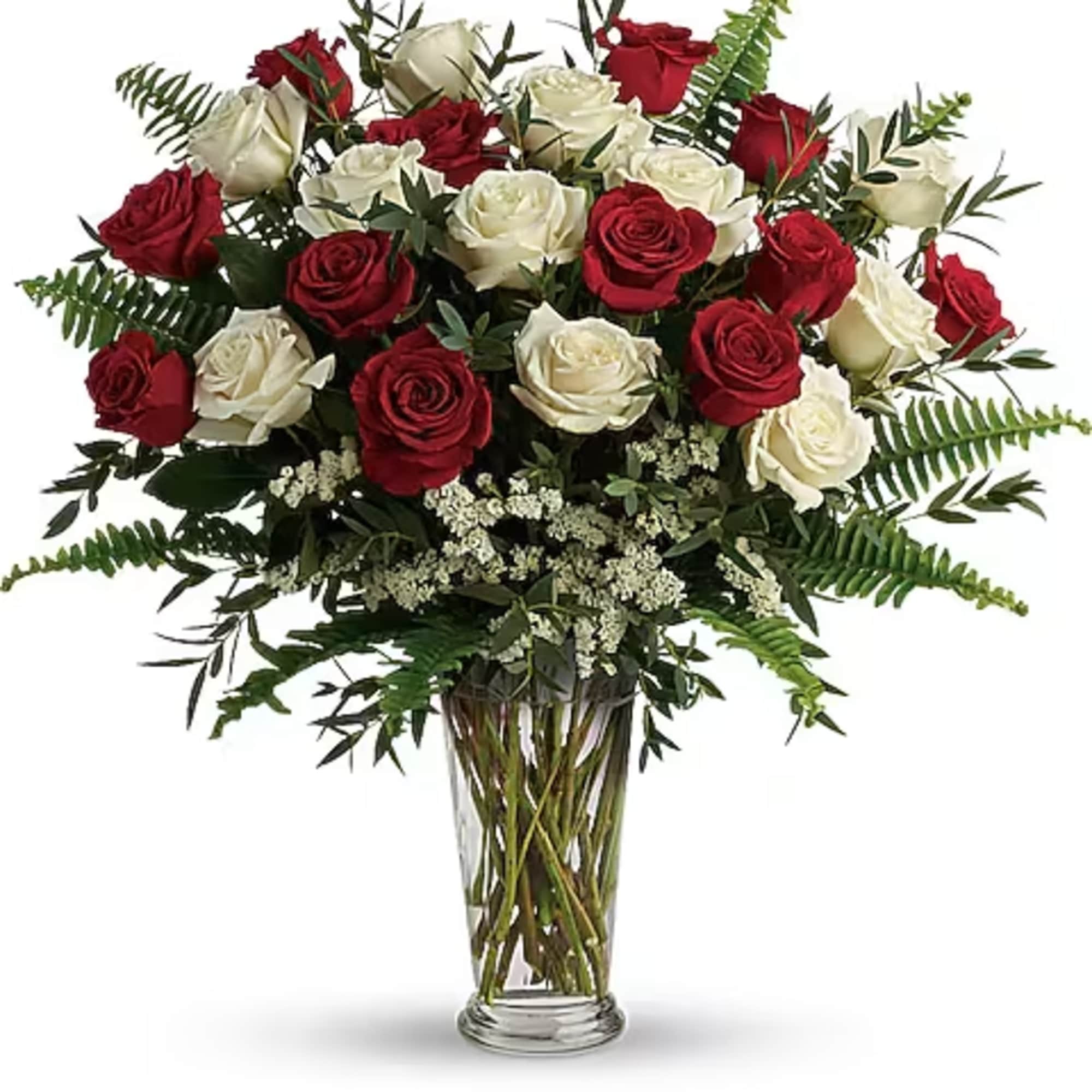 Red and white roses arranged in a clear glass vase