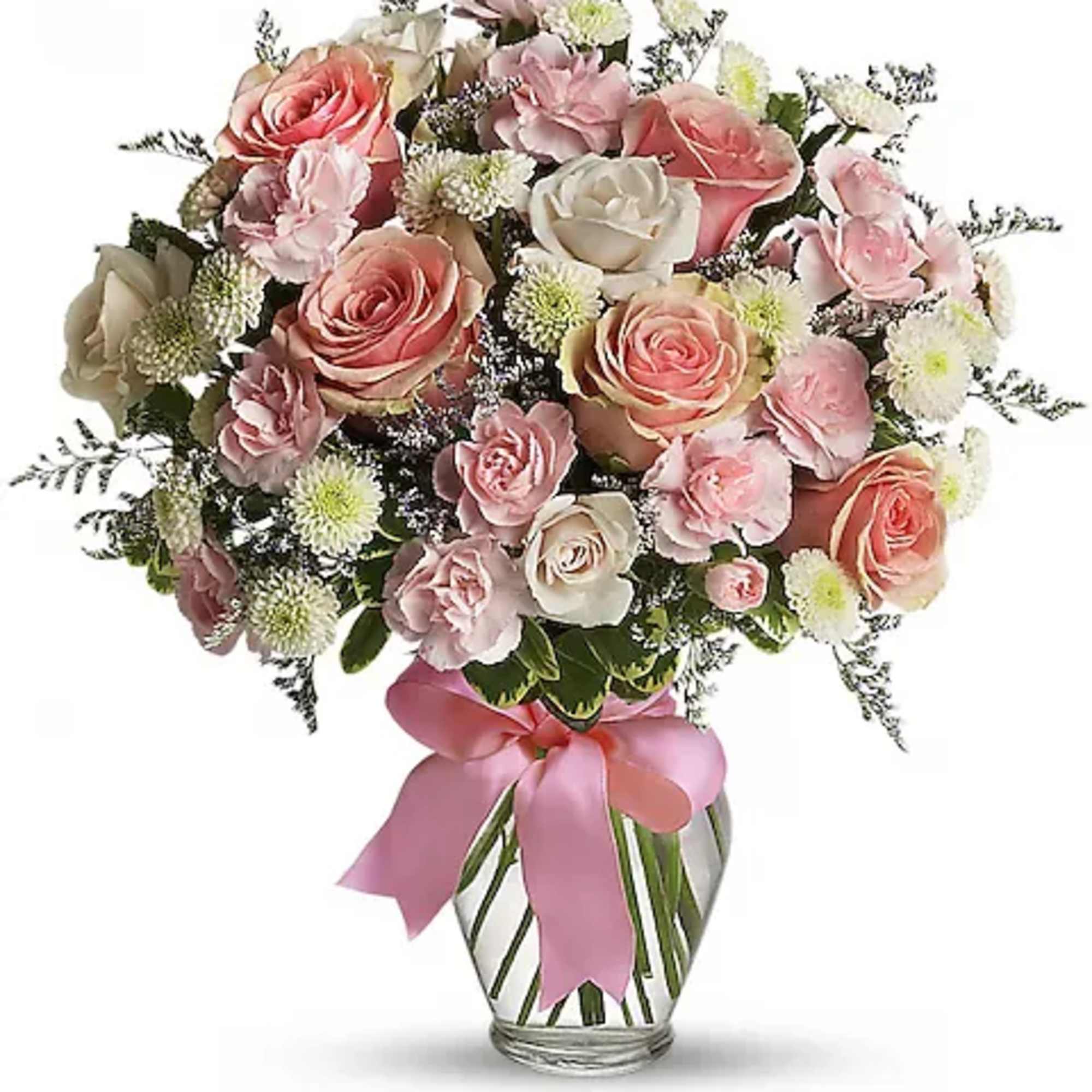Pink and white rose bouquet in a striped glass vase with a pink ribbon