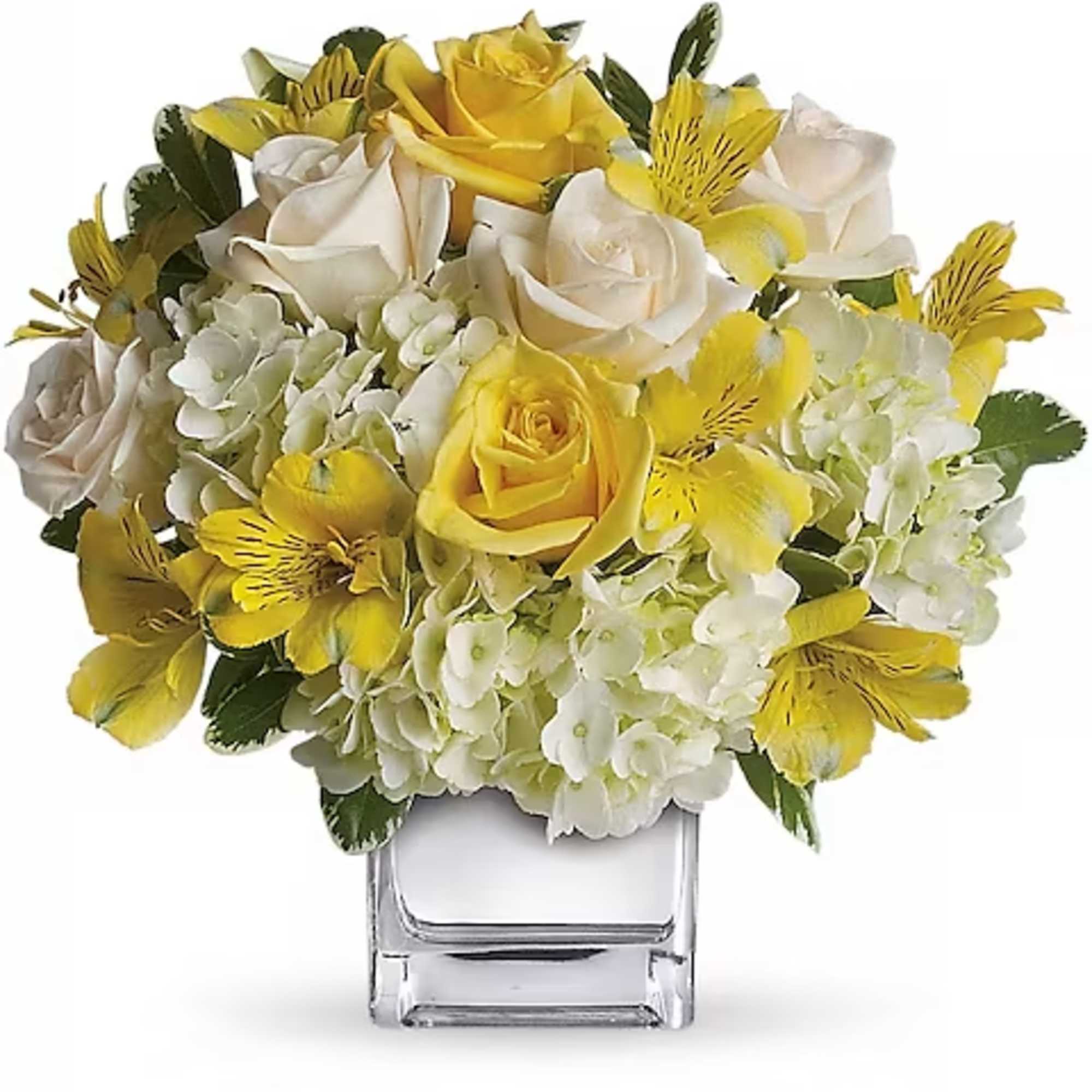 Yellow and white rose bouquet in a clear square vase
