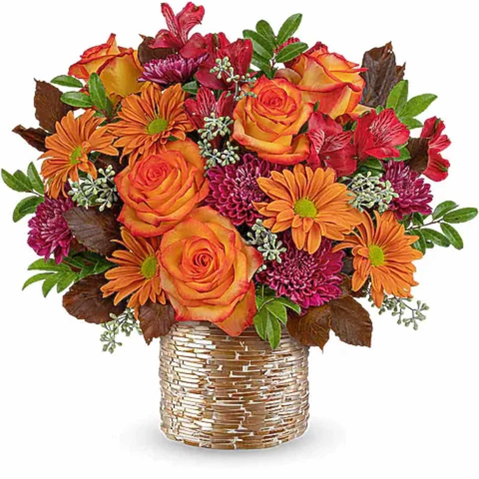 Orange roses and daisies in a woven vase