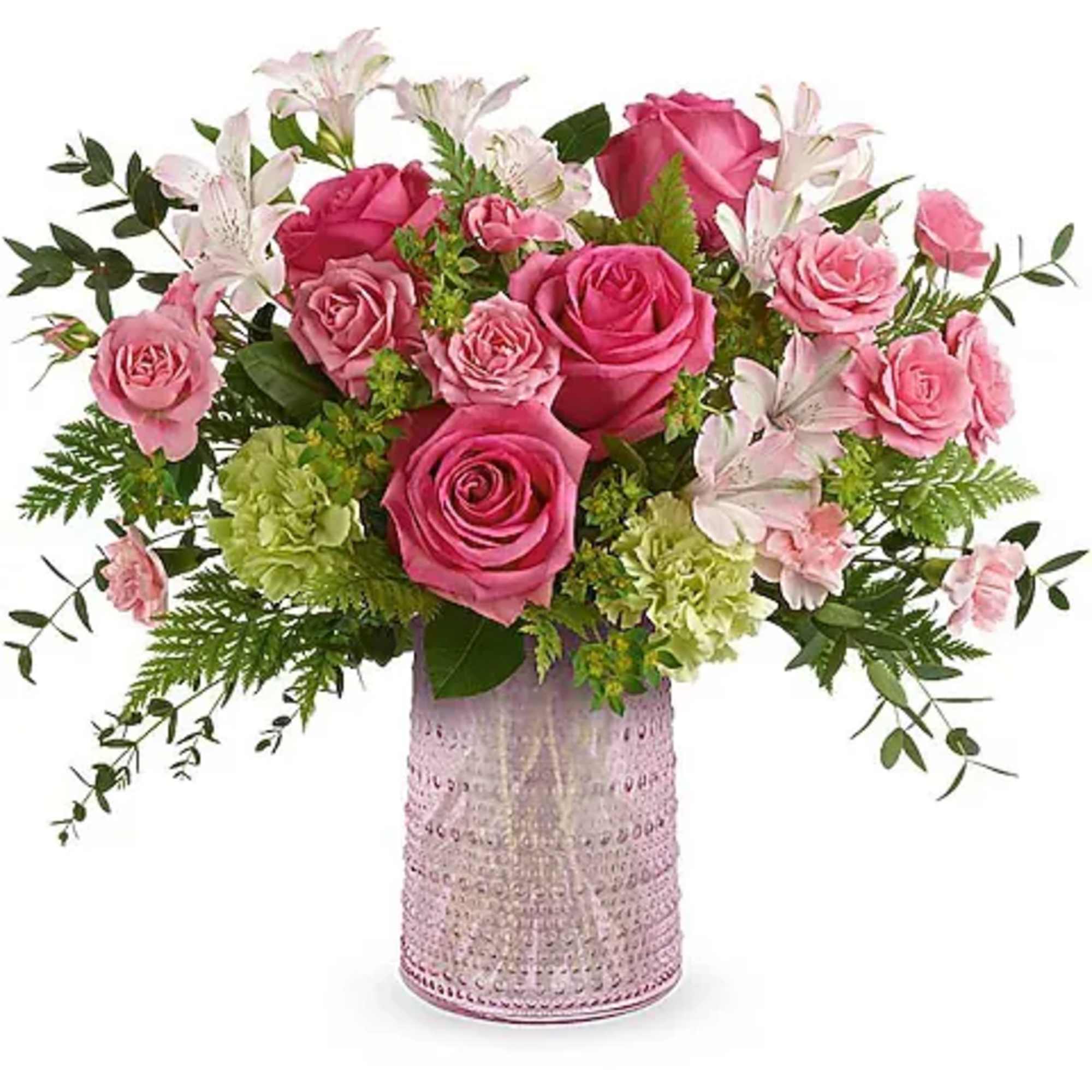 Pink roses and white lilies arranged in a pink glass vase