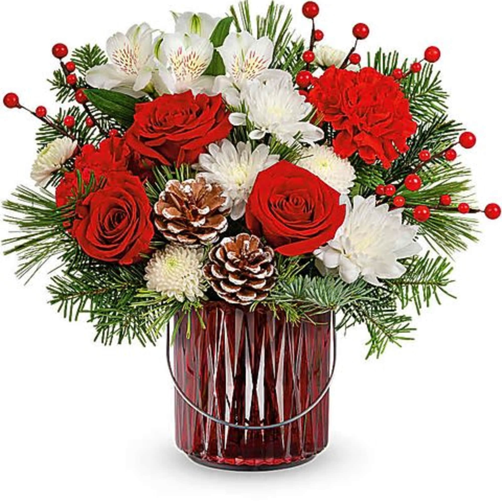 Red roses and white flowers in a red glass vase with pinecones