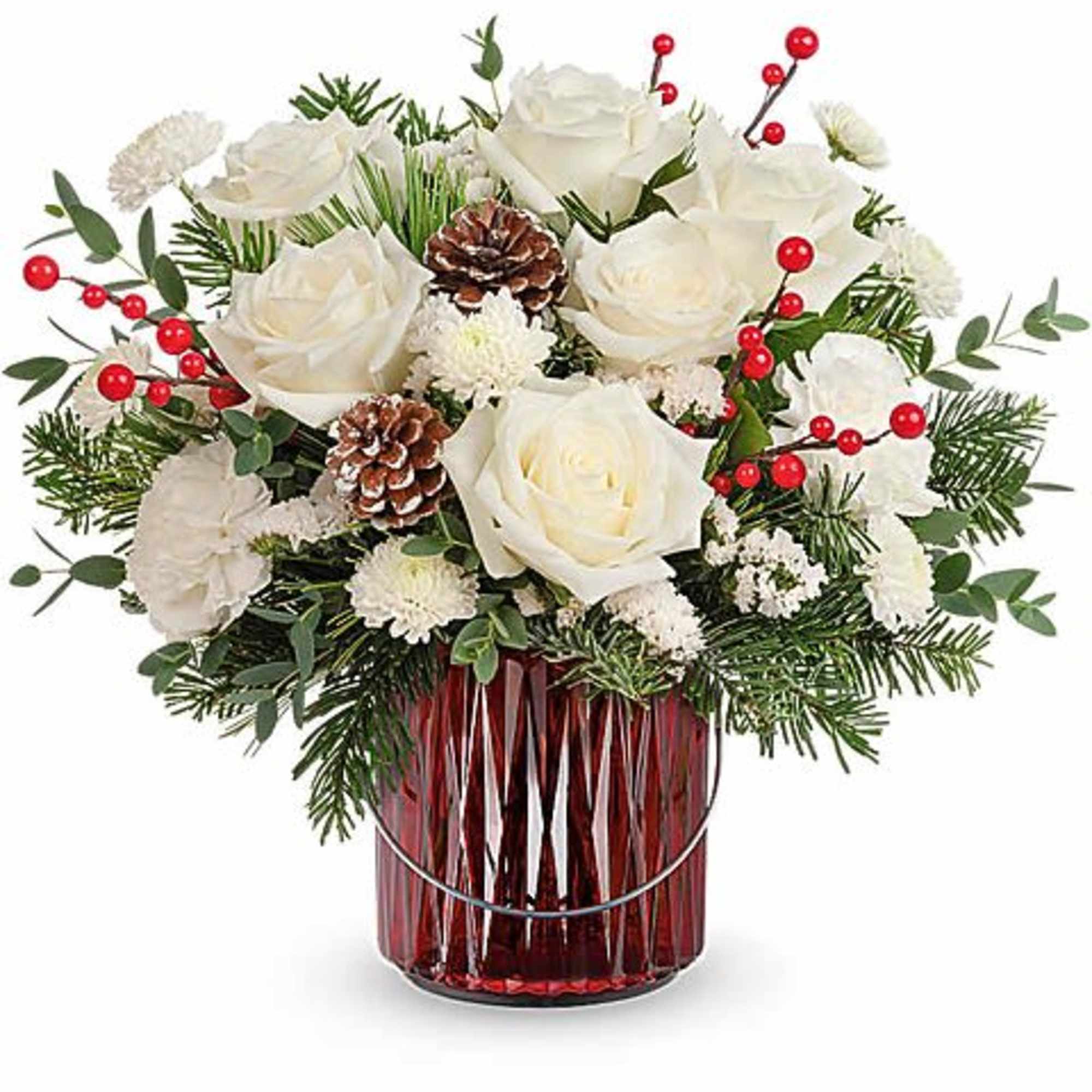 White roses in a red glass vase with pinecones and red berries