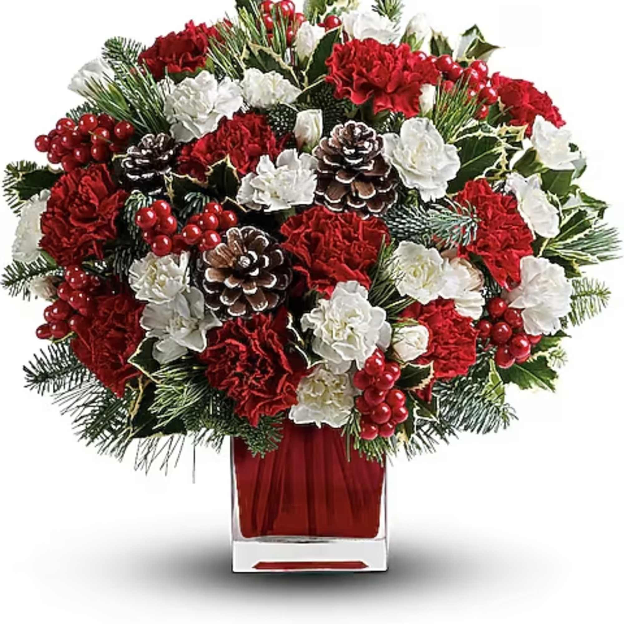 Red and white floral arrangement with pinecones and berries in a clear vase