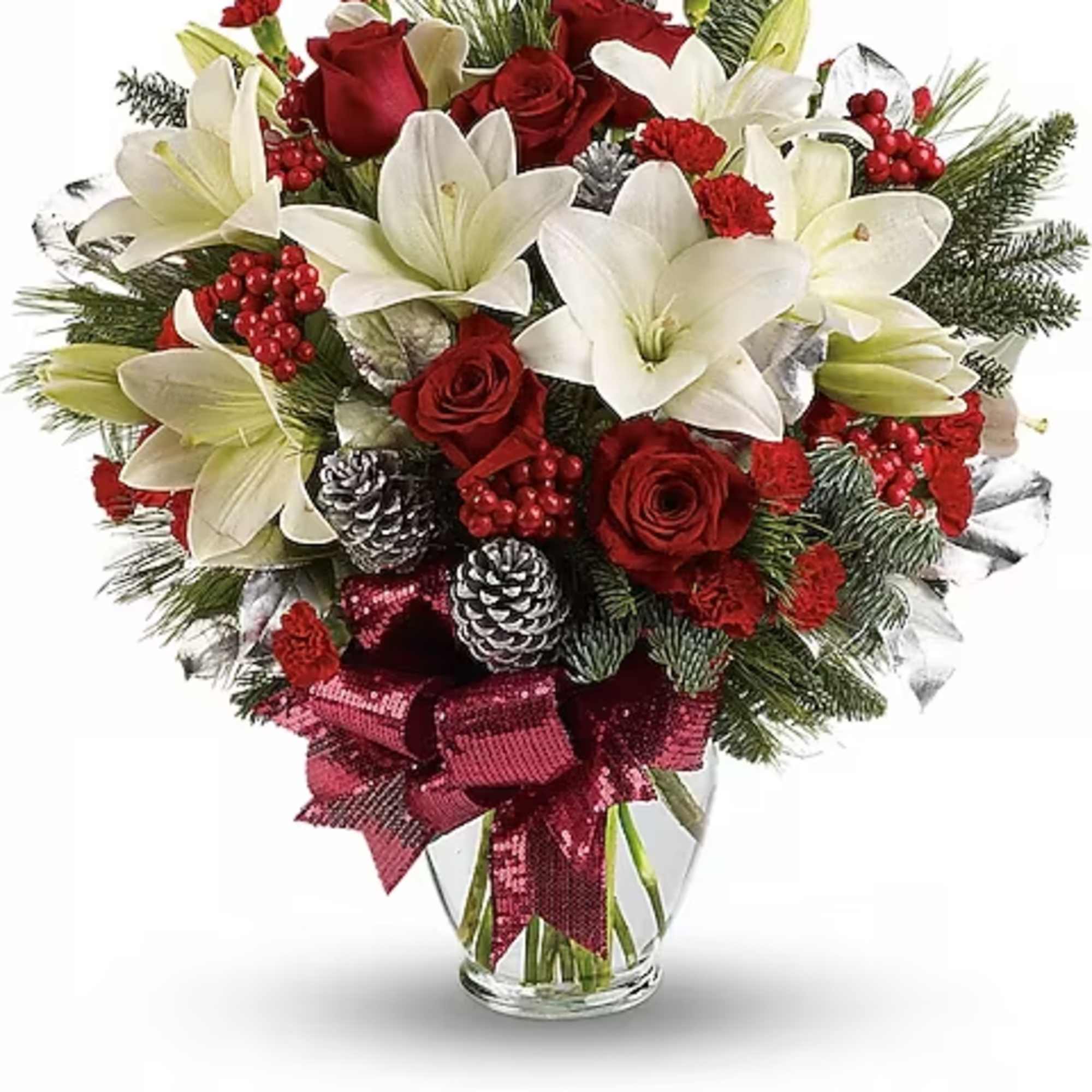 Red roses and white lilies in a glass vase with a burgundy ribbon