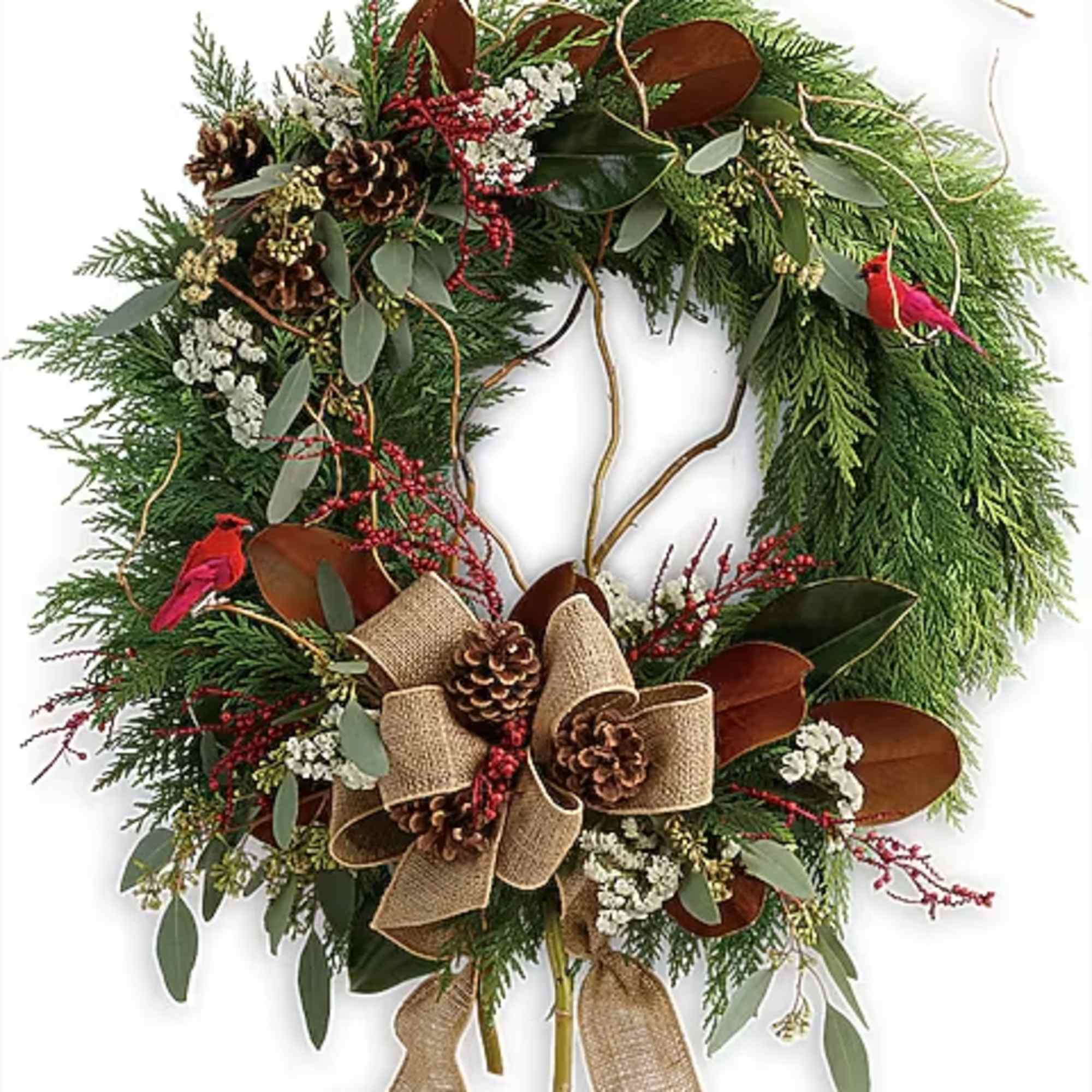 Holiday wreath with pine, berries, pinecones, and burlap ribbon