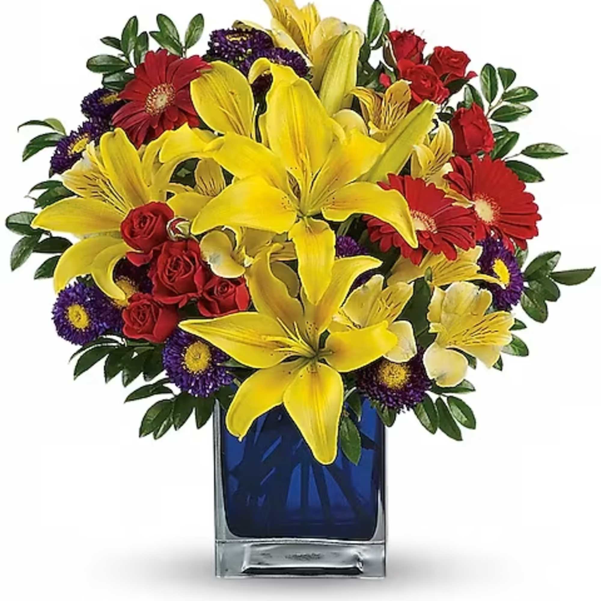 Bouquet of yellow lilies, red roses, and purple daisies in a blue glass vase