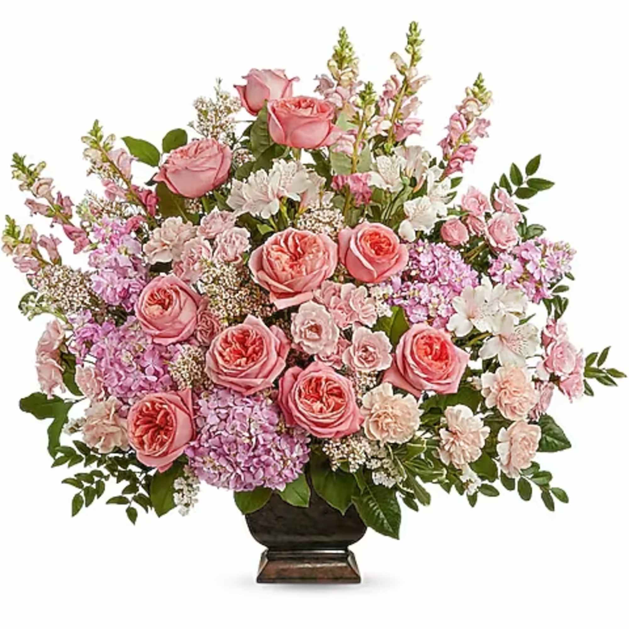 Pink roses and mixed pastel flowers in a dark urn vase