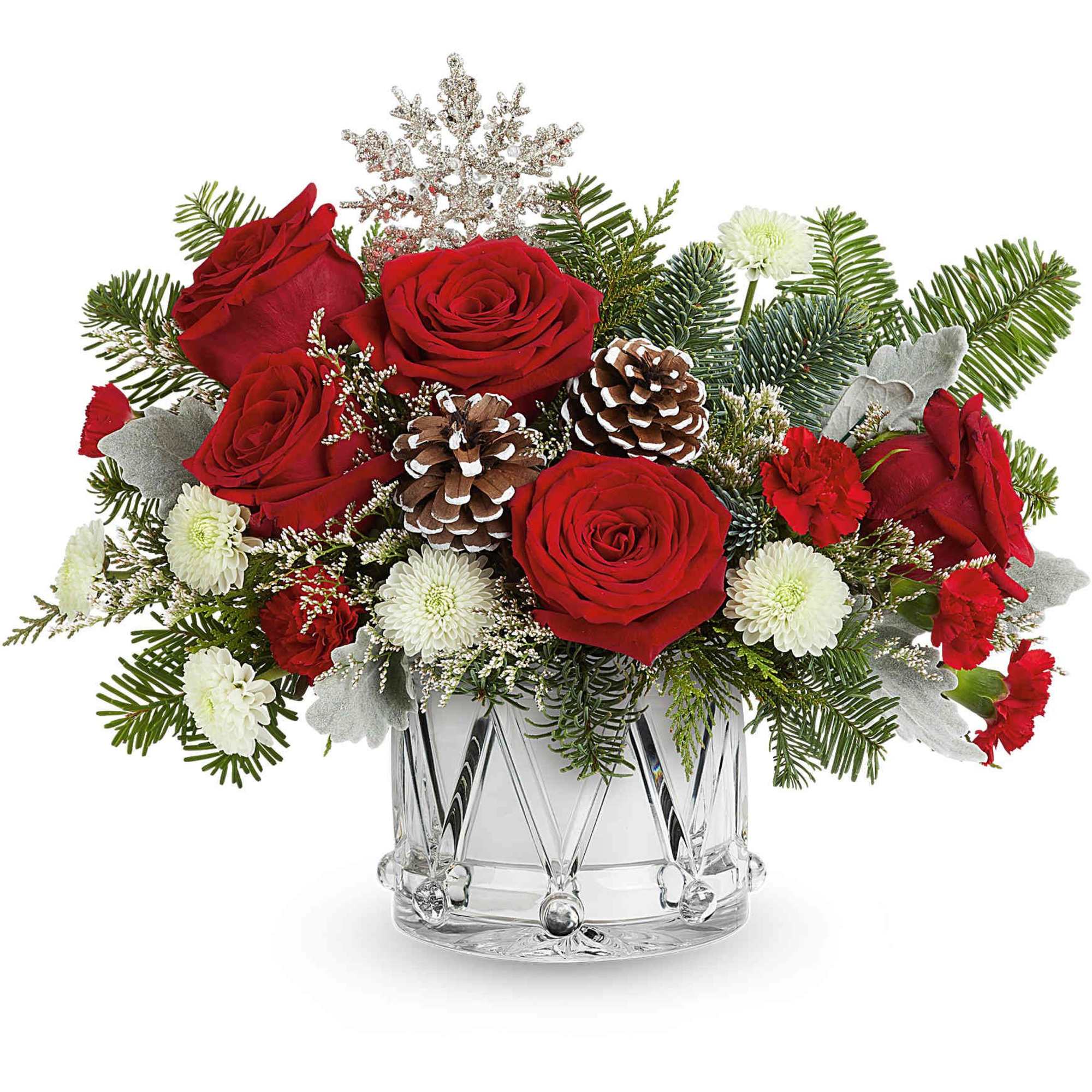 Red roses and white mums in a clear glass vase with pinecones