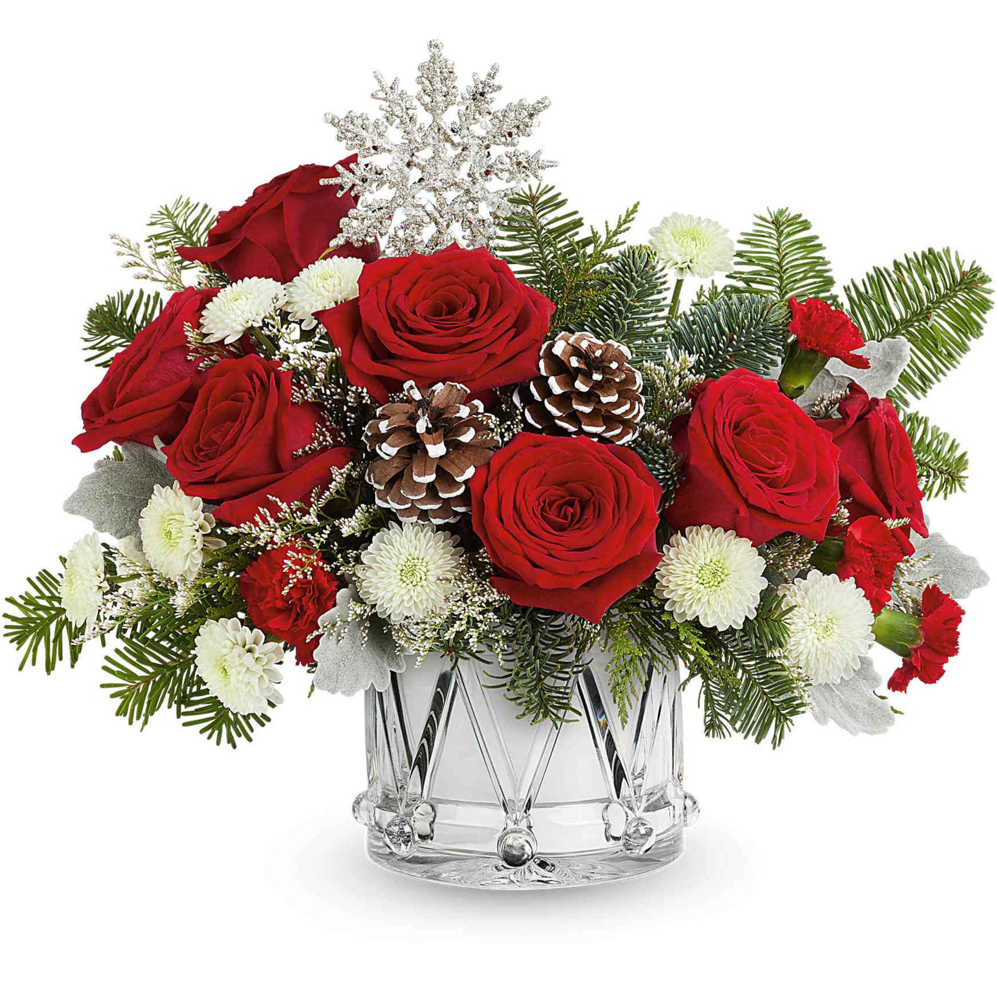 Red roses and white mums in a clear glass vase with pinecones