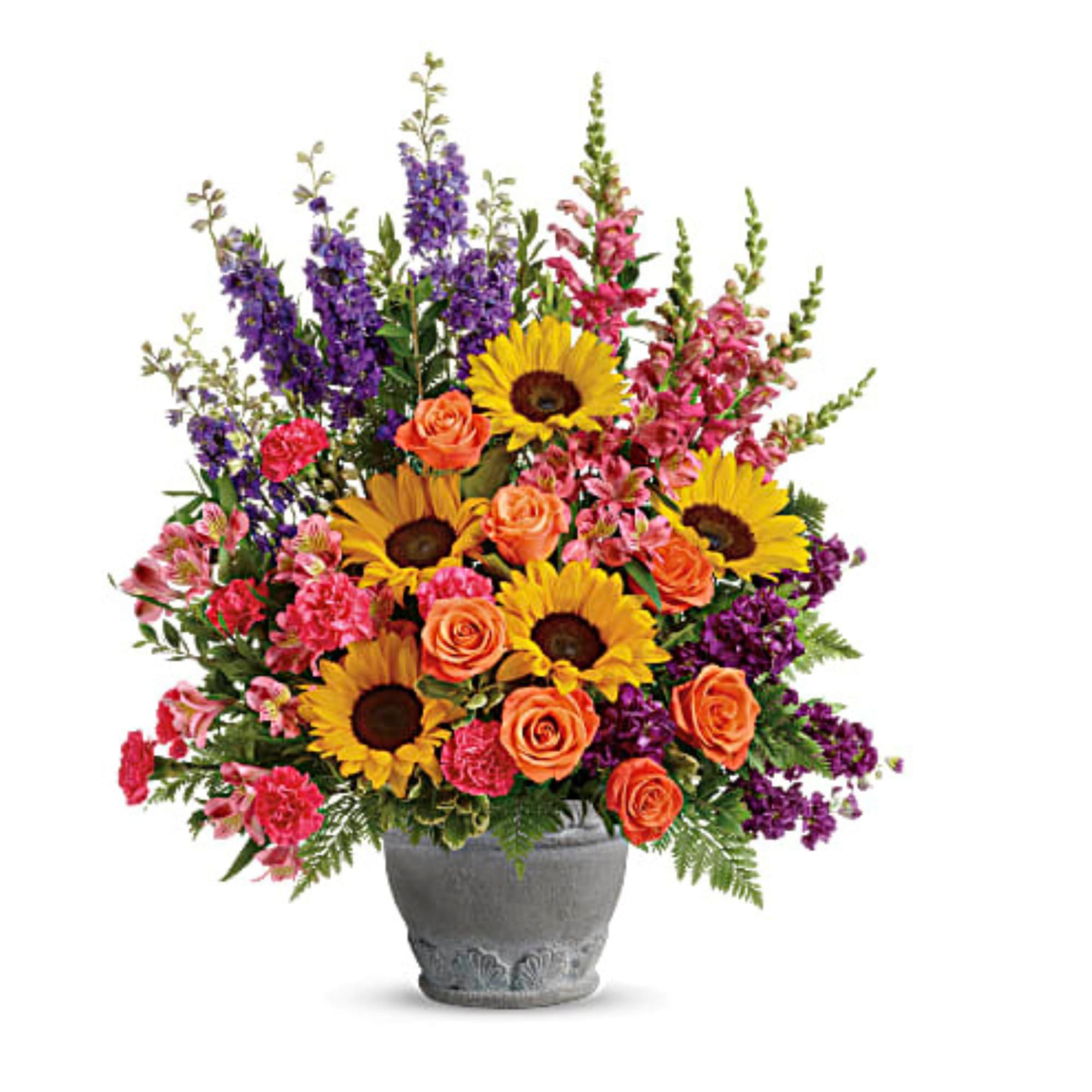 Colorful bouquet of sunflowers, roses, and purple flowers in a gray vase