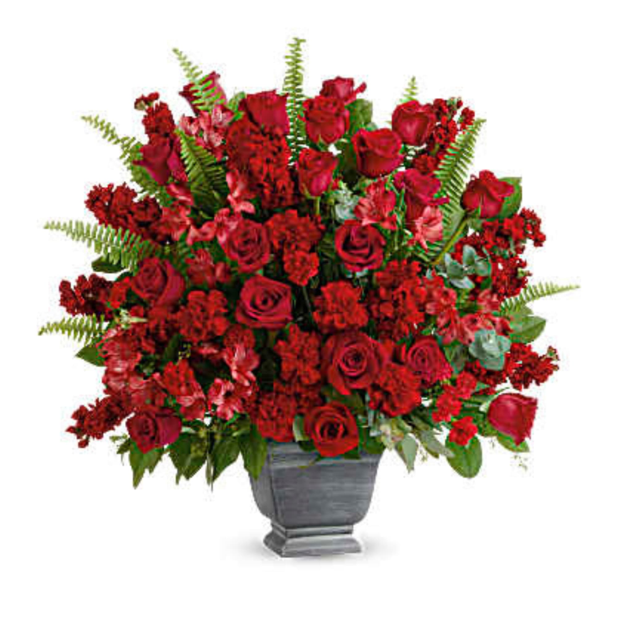 Large red rose arrangement in a gray urn vase