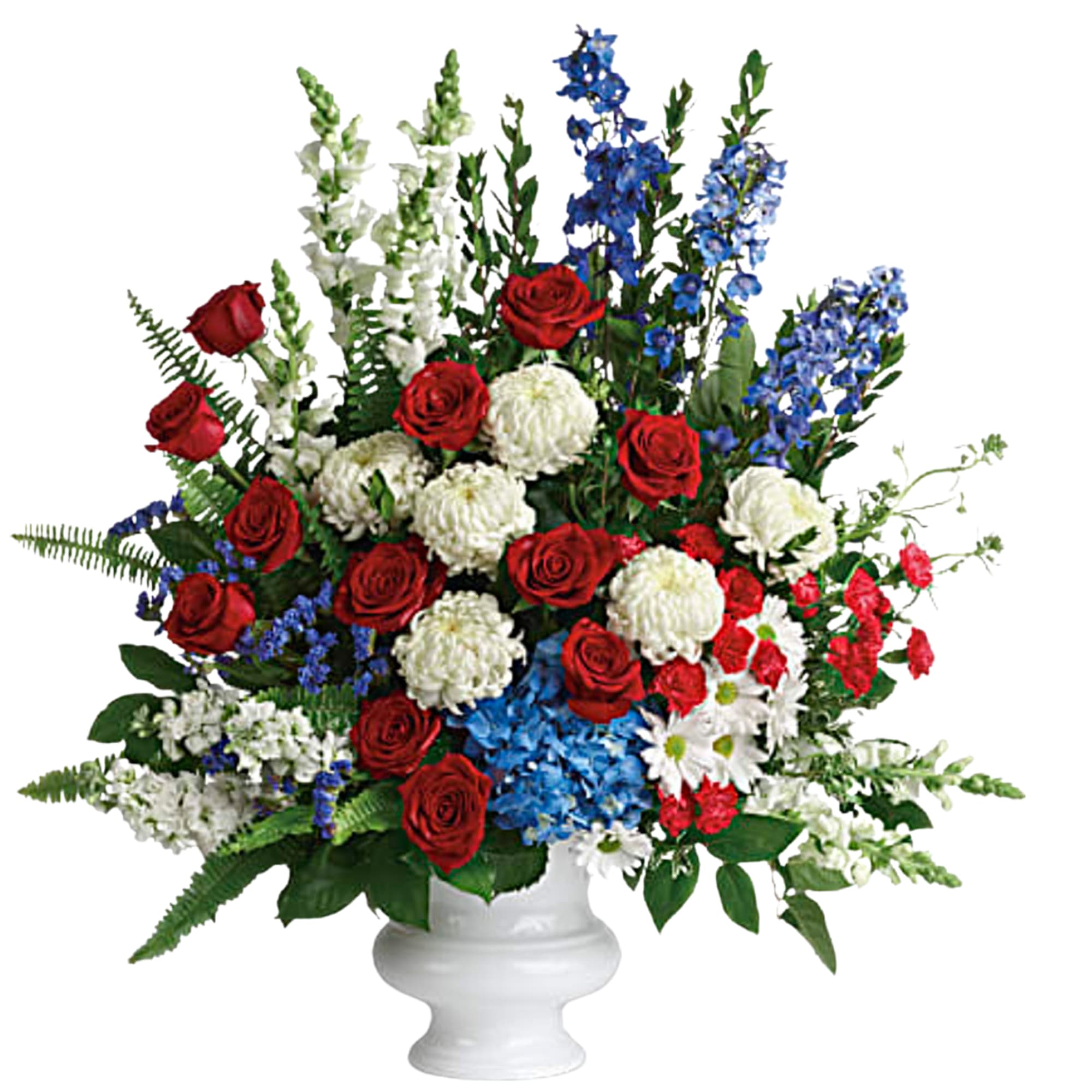 Red roses, white blooms, and blue flowers in a white vase