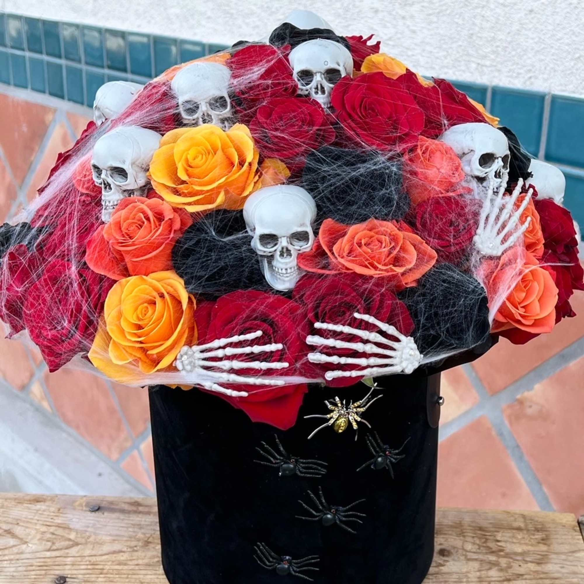 Dare to decorate with darkness. This hauntingly beautiful Halloween bouquet features black