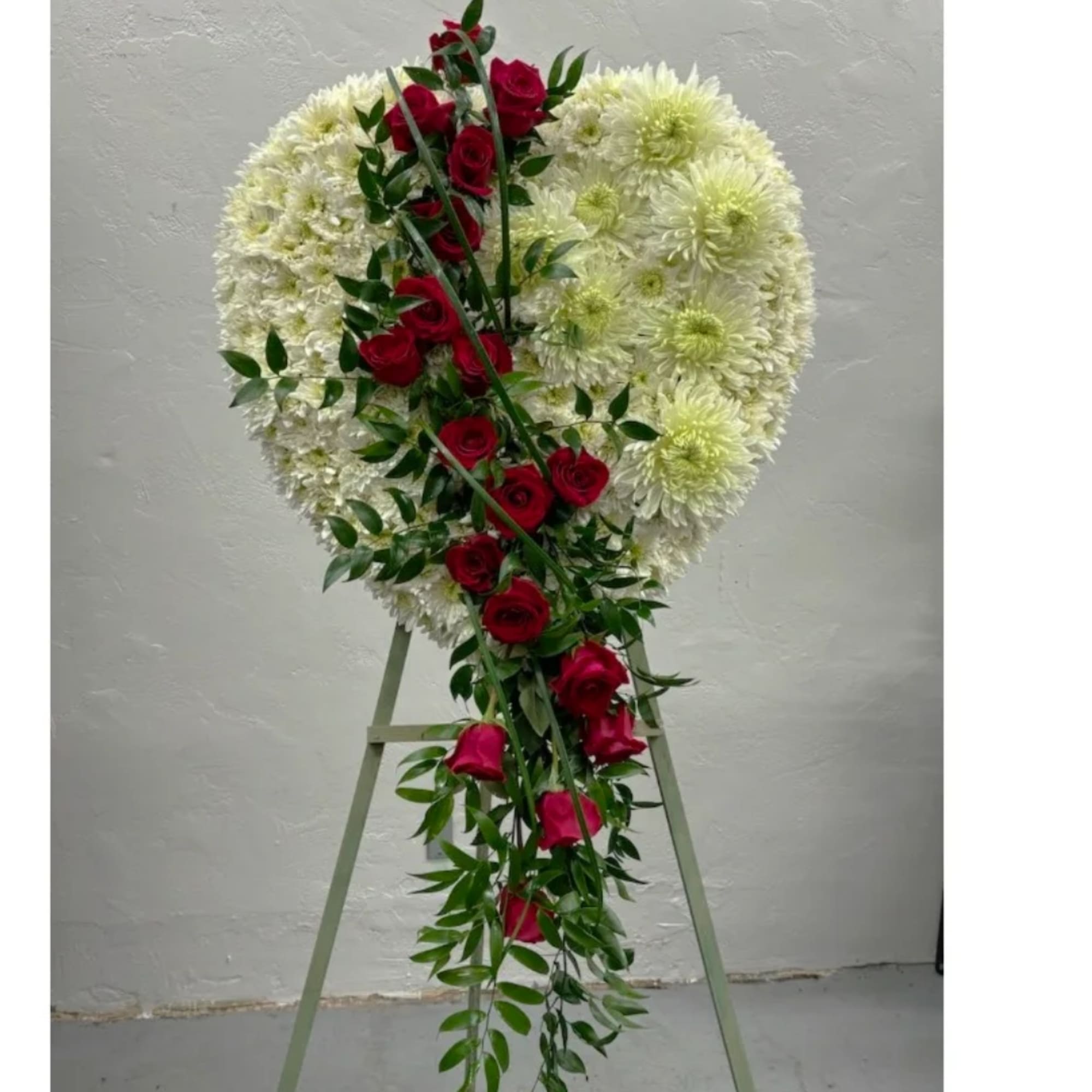 Heart-shaped floral standing spray with white blooms and red roses
