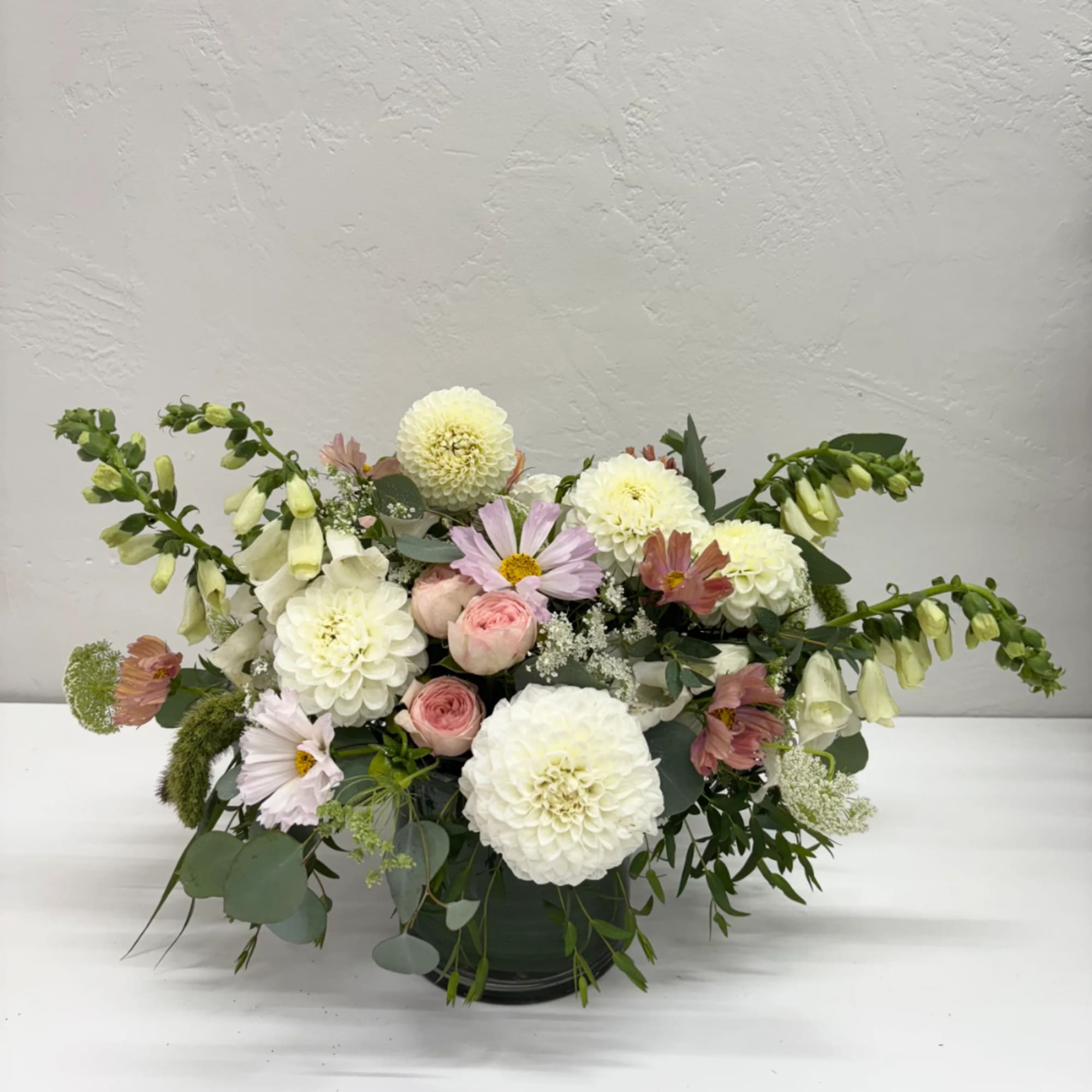 Mixed bouquet in a dark vase with white and pink blooms
