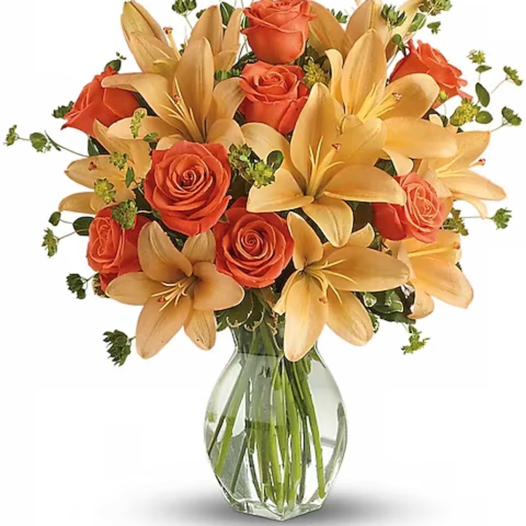Orange roses and yellow lilies arranged in a clear glass vase