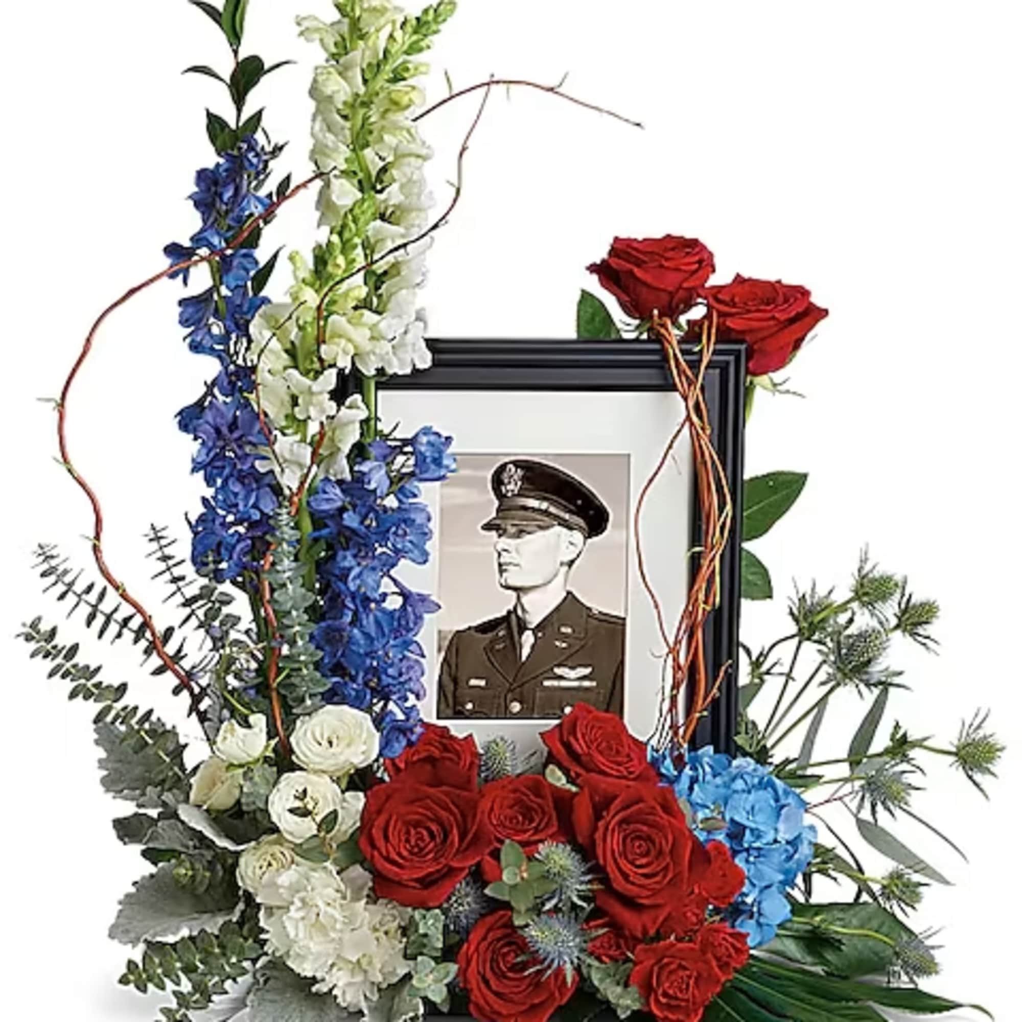 Floral memorial frame with red roses, blue and white flowers, and a portrait photo