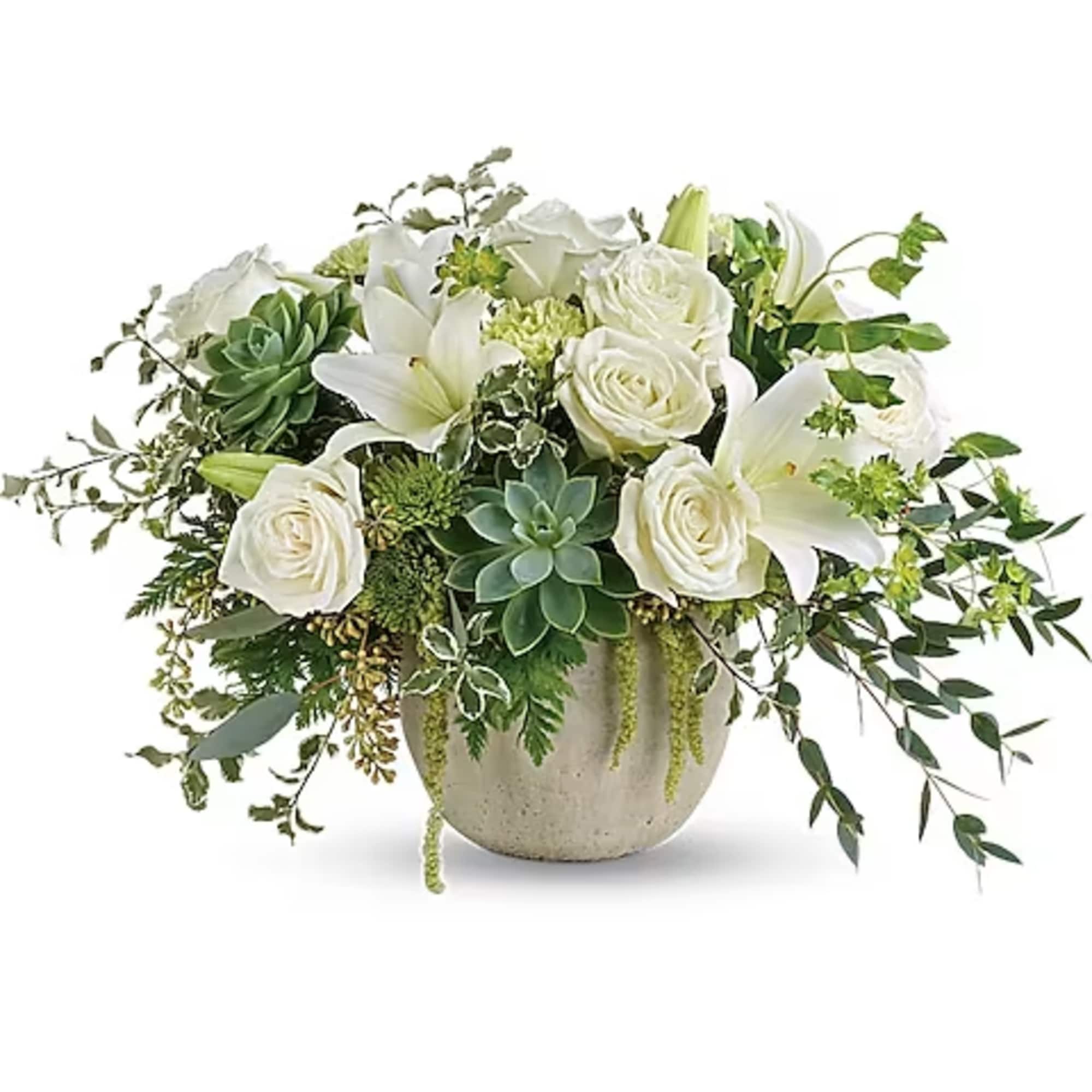 White roses and lilies arranged in a round vase with succulents and greenery