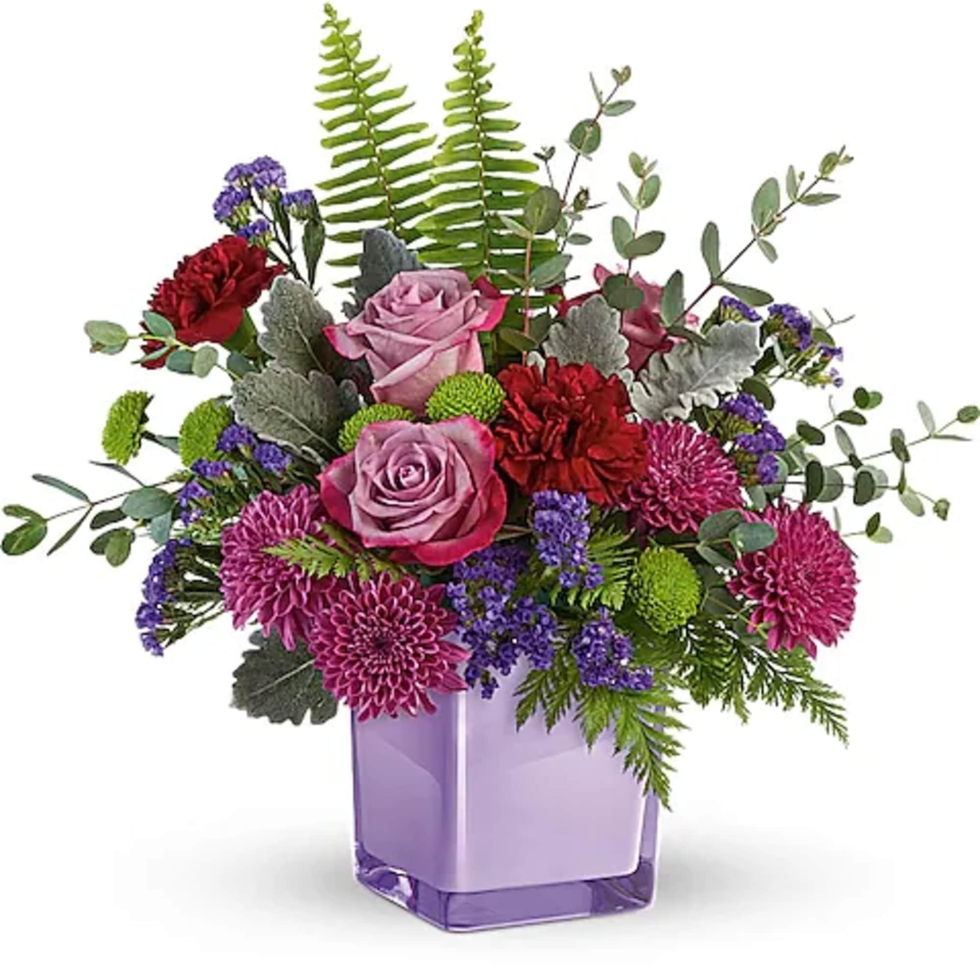 Purple and pink floral arrangement in a lavender glass vase